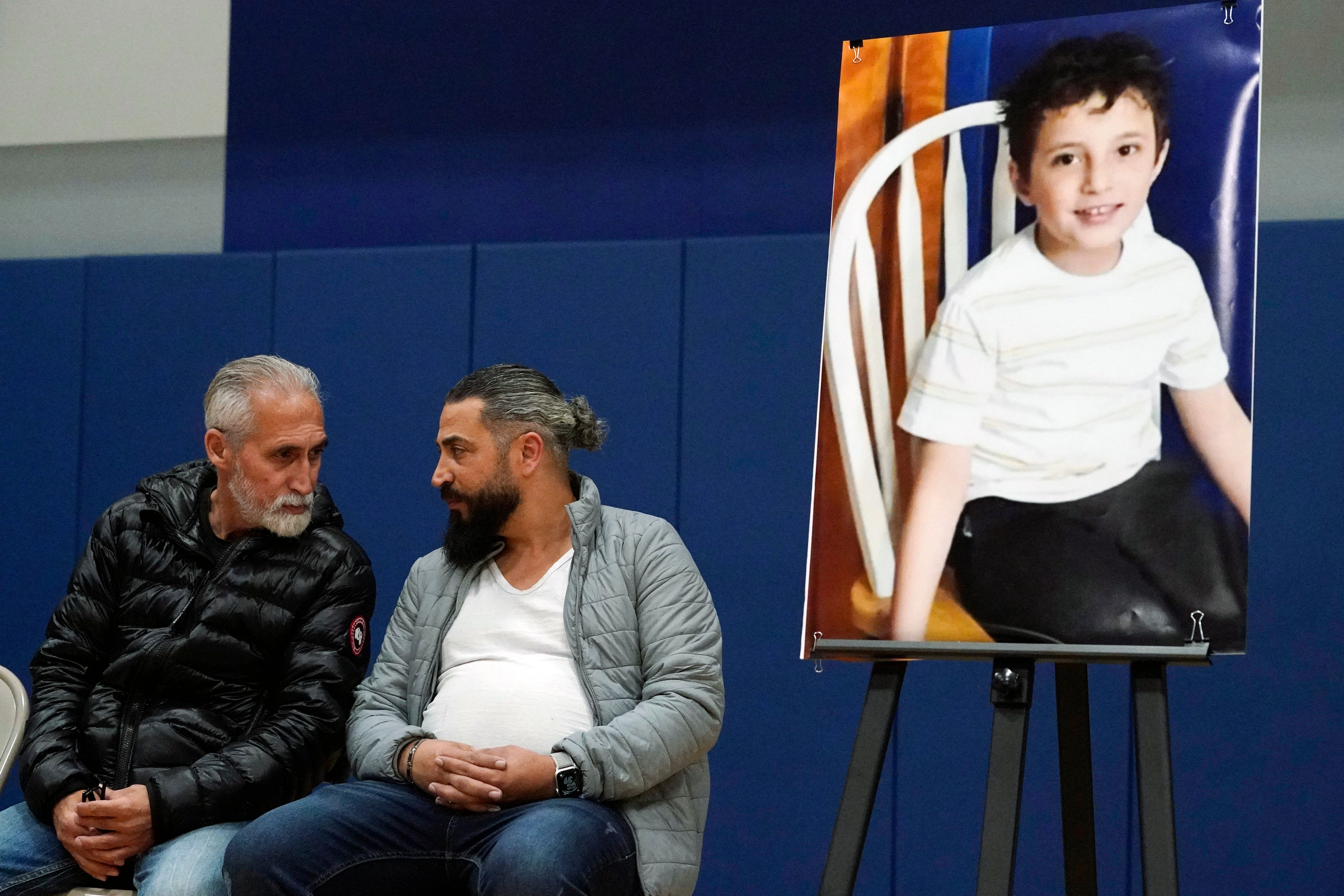 Wadee Alfayoumi's father, Oday Al Fayoume, seated right, and his uncle Mahmoud Yousef attend a vigil for Wadee at Prairie Activity and Recreation center in Plainfield, Ill., Oct. 17, 2023. (AP Photo/Nam Y. Huh, File)