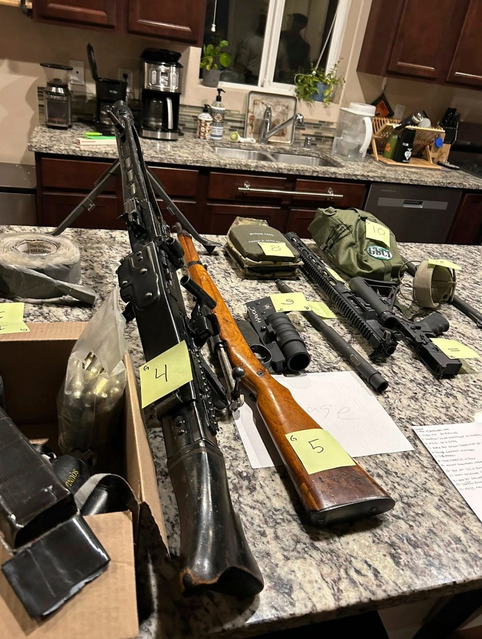 A cache of military weaponry is displayed during a raid at a home in Lacey, Washington