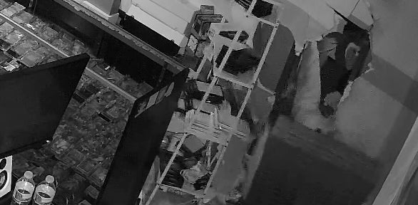 The suspected thieves first broke into a neighboring business and then used a sledgehammer to break through the connecting wall and enter the collectibles store, according to police and security video