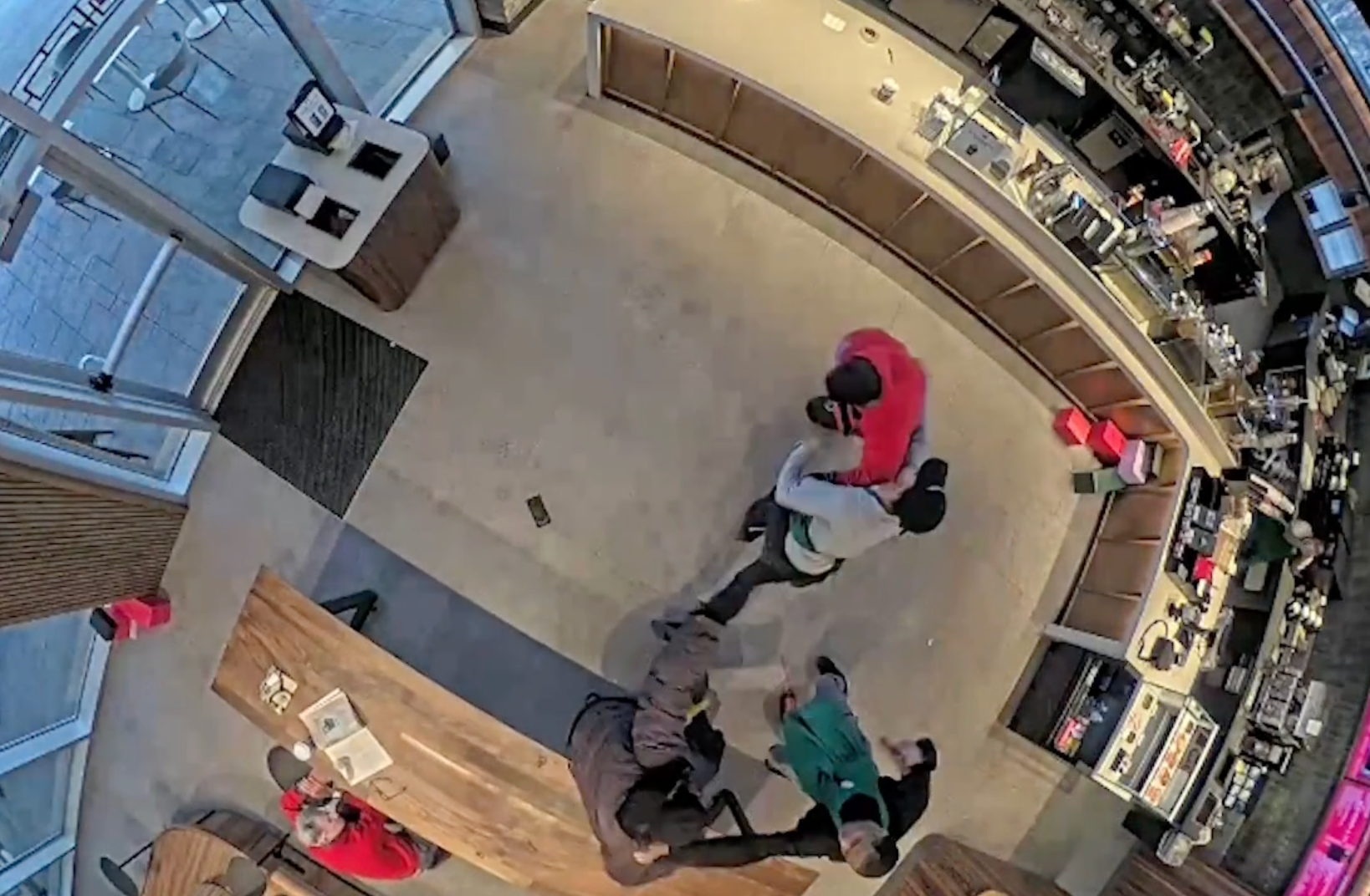 Michael Harris said he and another Starbucks employee 'started to fight' back against the robbers after realizing the gun was fake