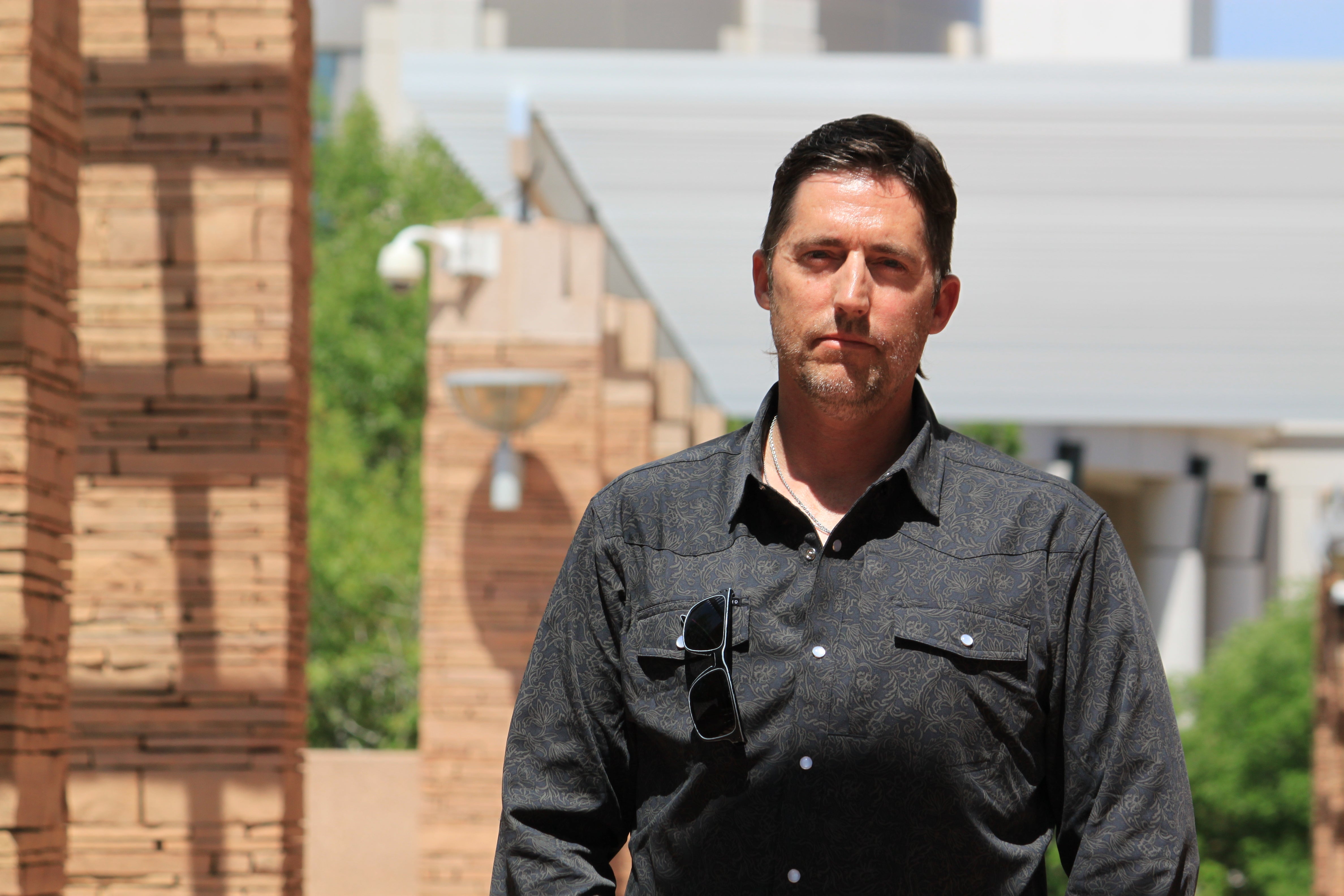DEA Special Agent David Howell, who filed a whistleblower complaint, poses for a portrait outside the U.S. district courthouse in Albuquerque