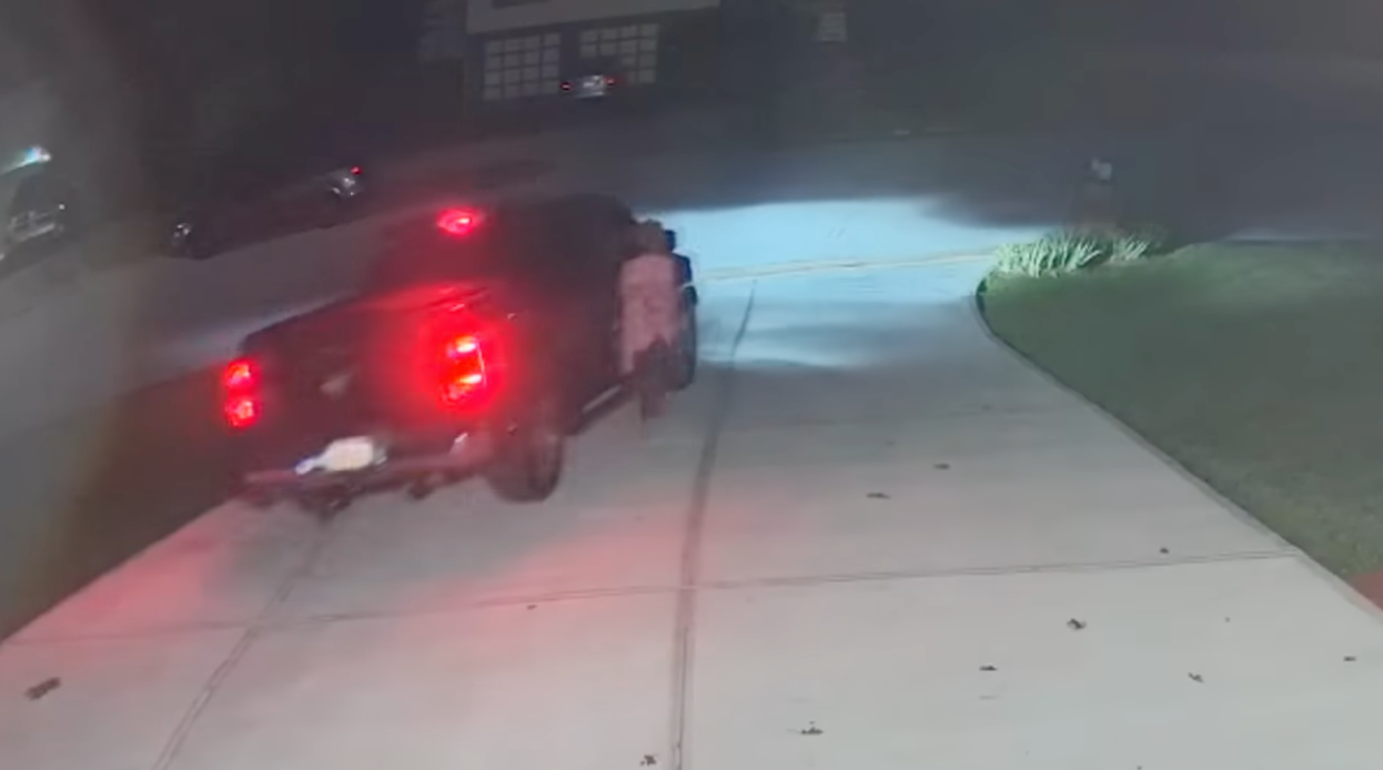 Janice Frazier, 58, of Georgia, is seen trying to hold onto the handle of her ex-husband's truck as he drives away. She allegedly was trying to stop him from driving drunk, but fell under the truck and was run over and killed