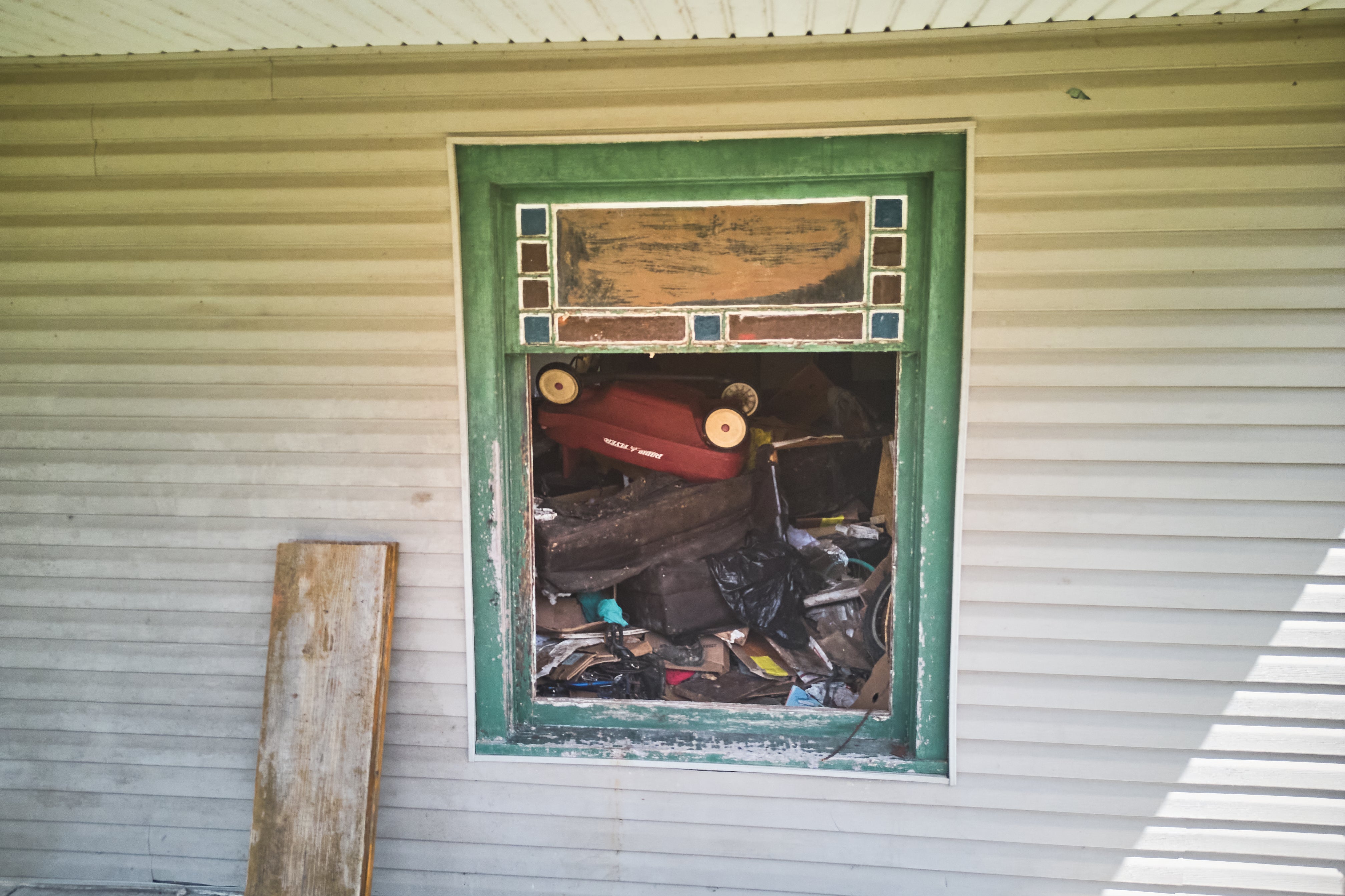Investigators reported finding an entire entrance blocked by garbage bags and boxes