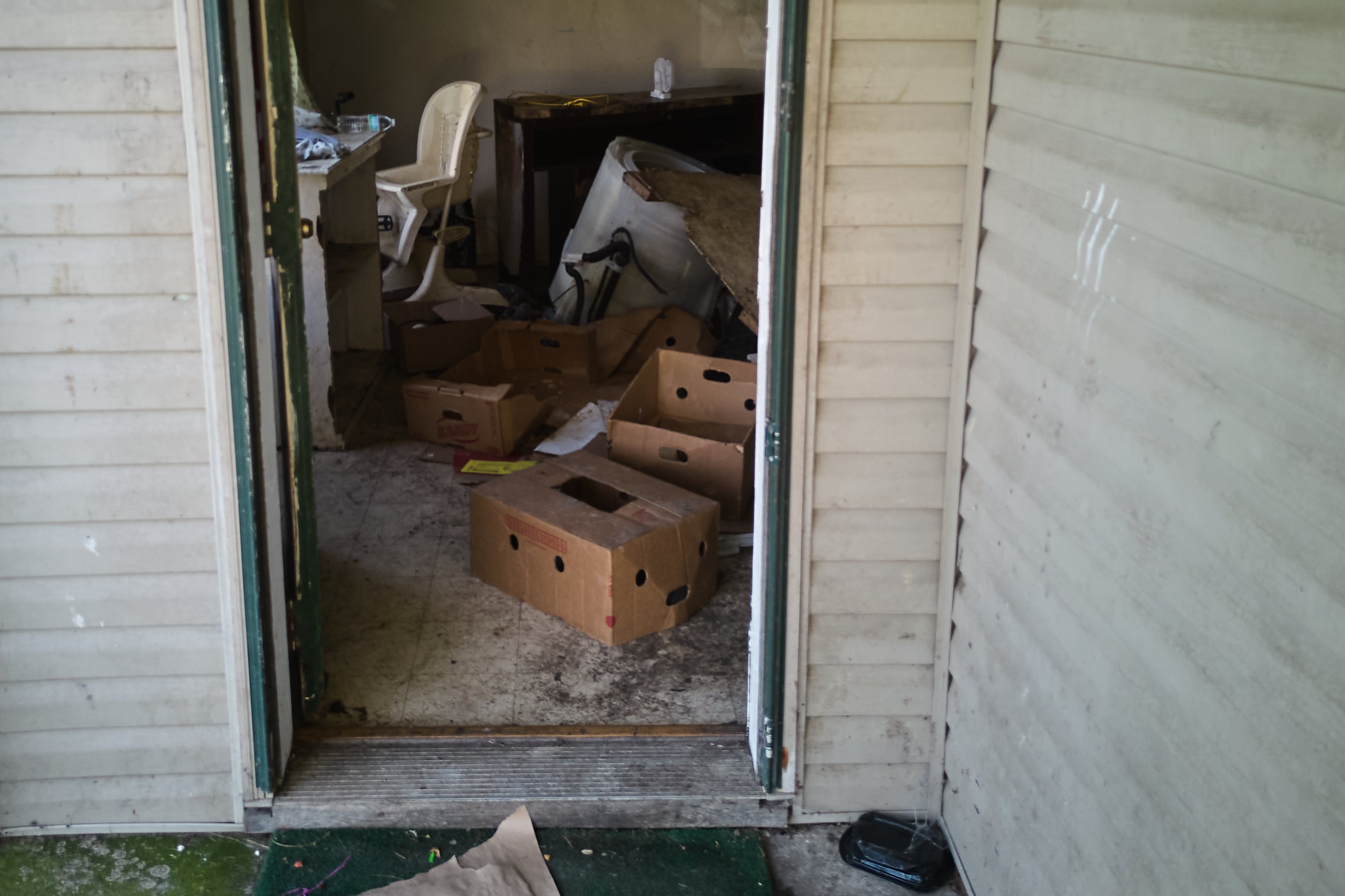 Items including a high chair are seen in a home where authorities say they removed 16 children and arrested four adults in Hamden, Ohio, Wednesday, July 1, 2026