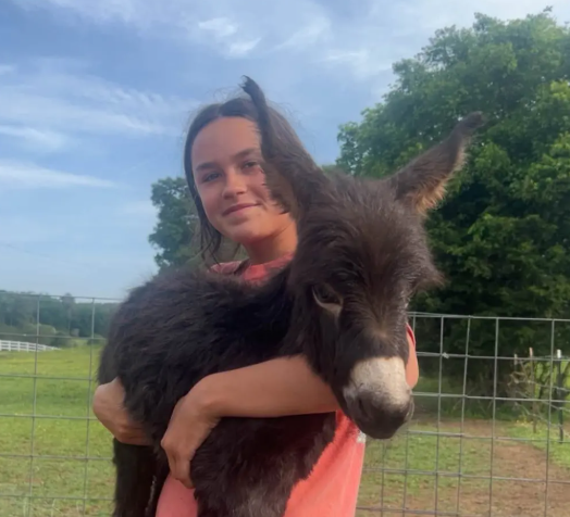 Hannah Israel with her donkey HeeHaw. The animal was shot and killed by Cedartown, Georgia, police officer Trenton Garner, who claimed the donkey 'charged' at him and a K-9 handler while they were searching for a missing girl on Israel's property