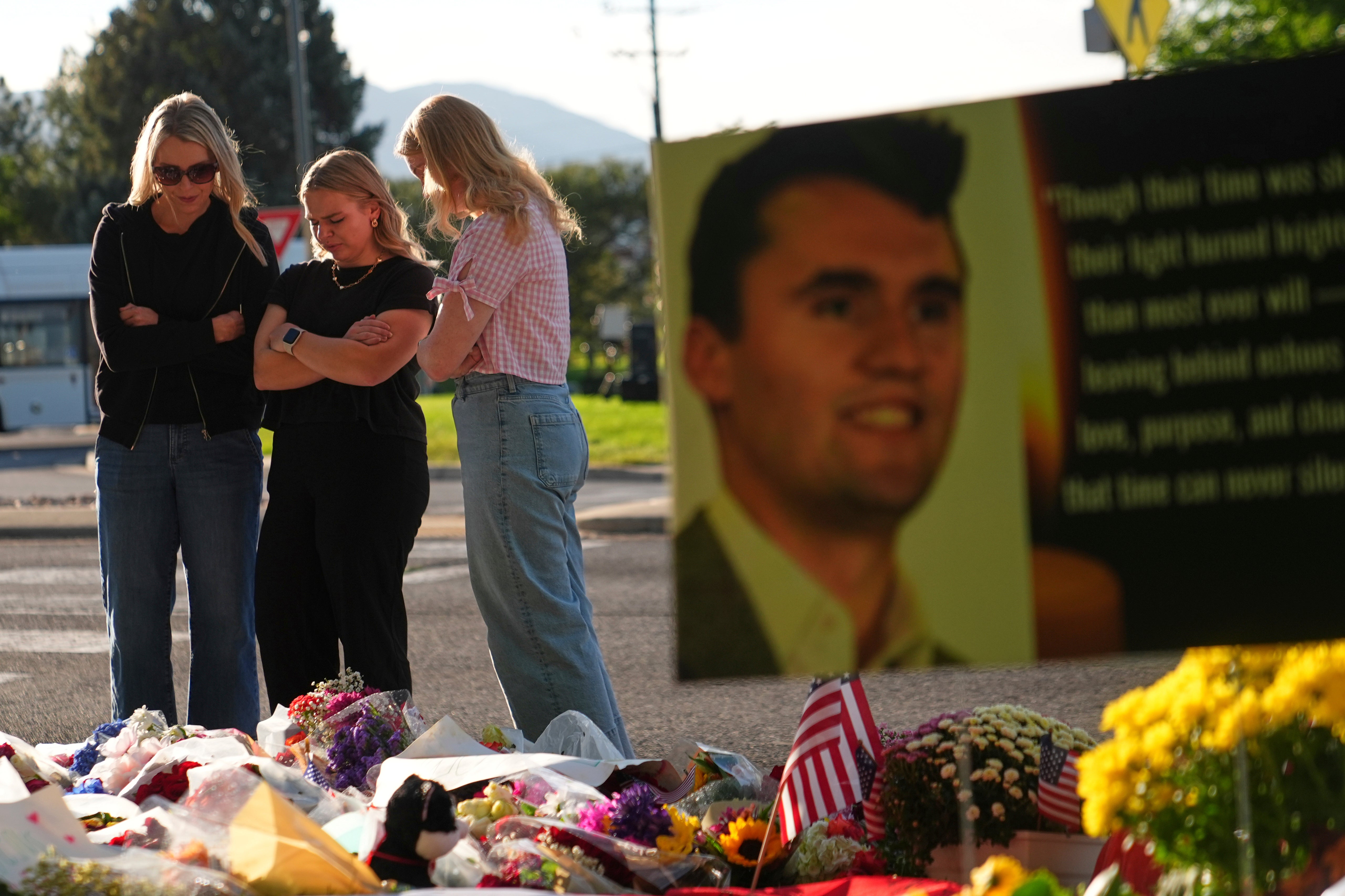 Women pray at a memorial outside Utah Valley University after Turning Point USA CEO and co-founder Charlie Kirk was shot and killed