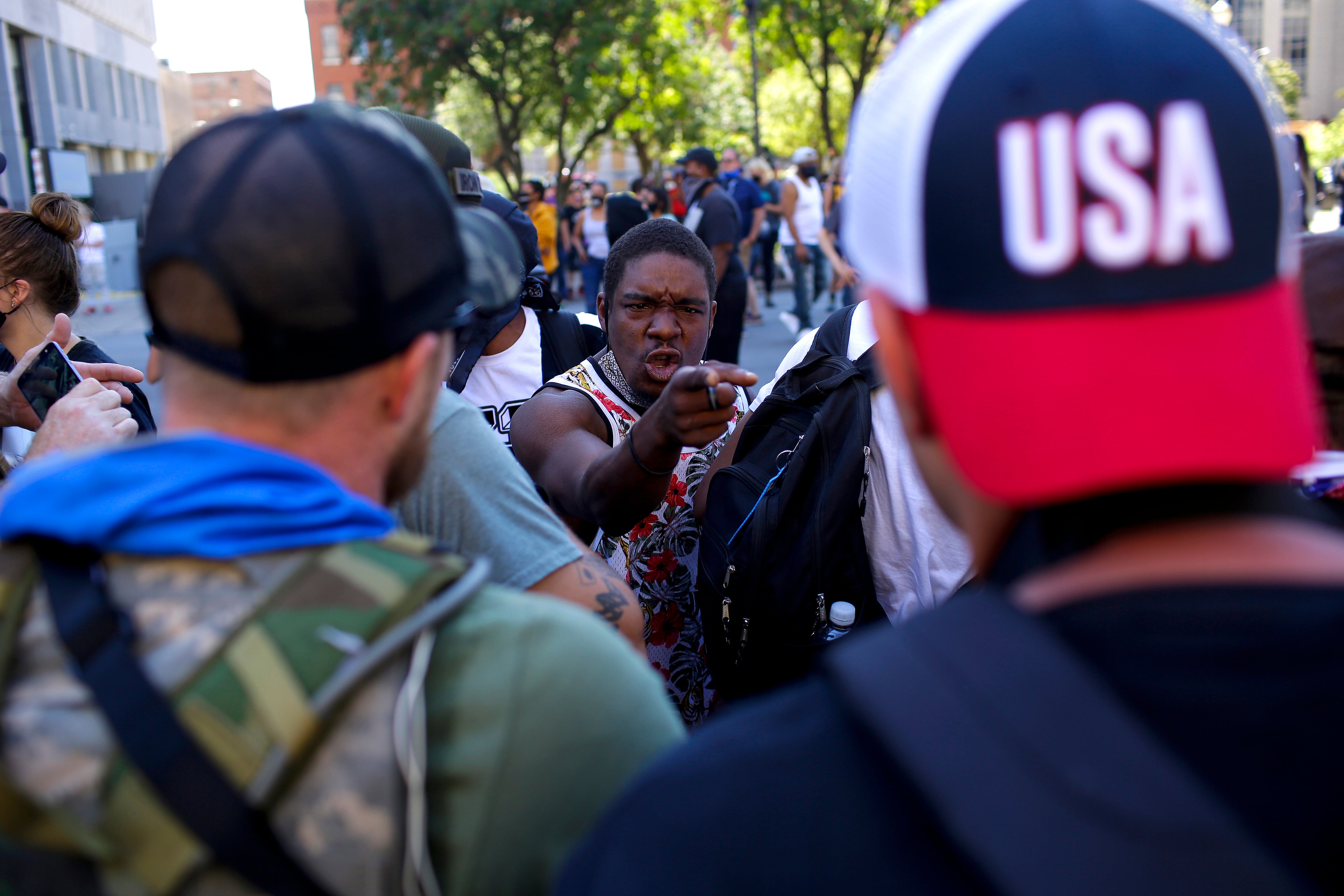 A protester demanding justice in the police killing of Breonna Taylor confronts far-right activists near city hall in Louisville on Saturday