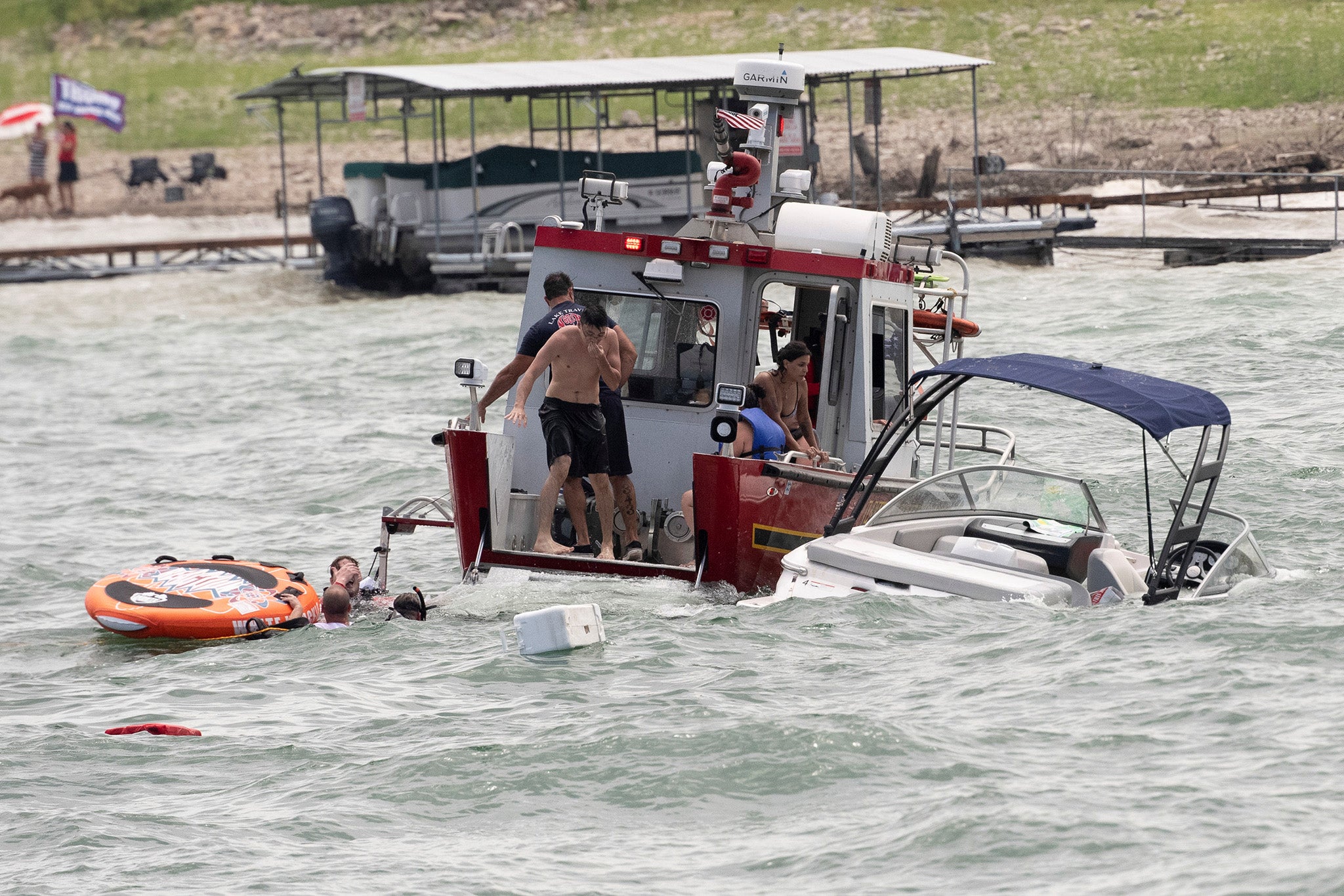 Trump supporters are rescued during a boating parade for the president on Saturday