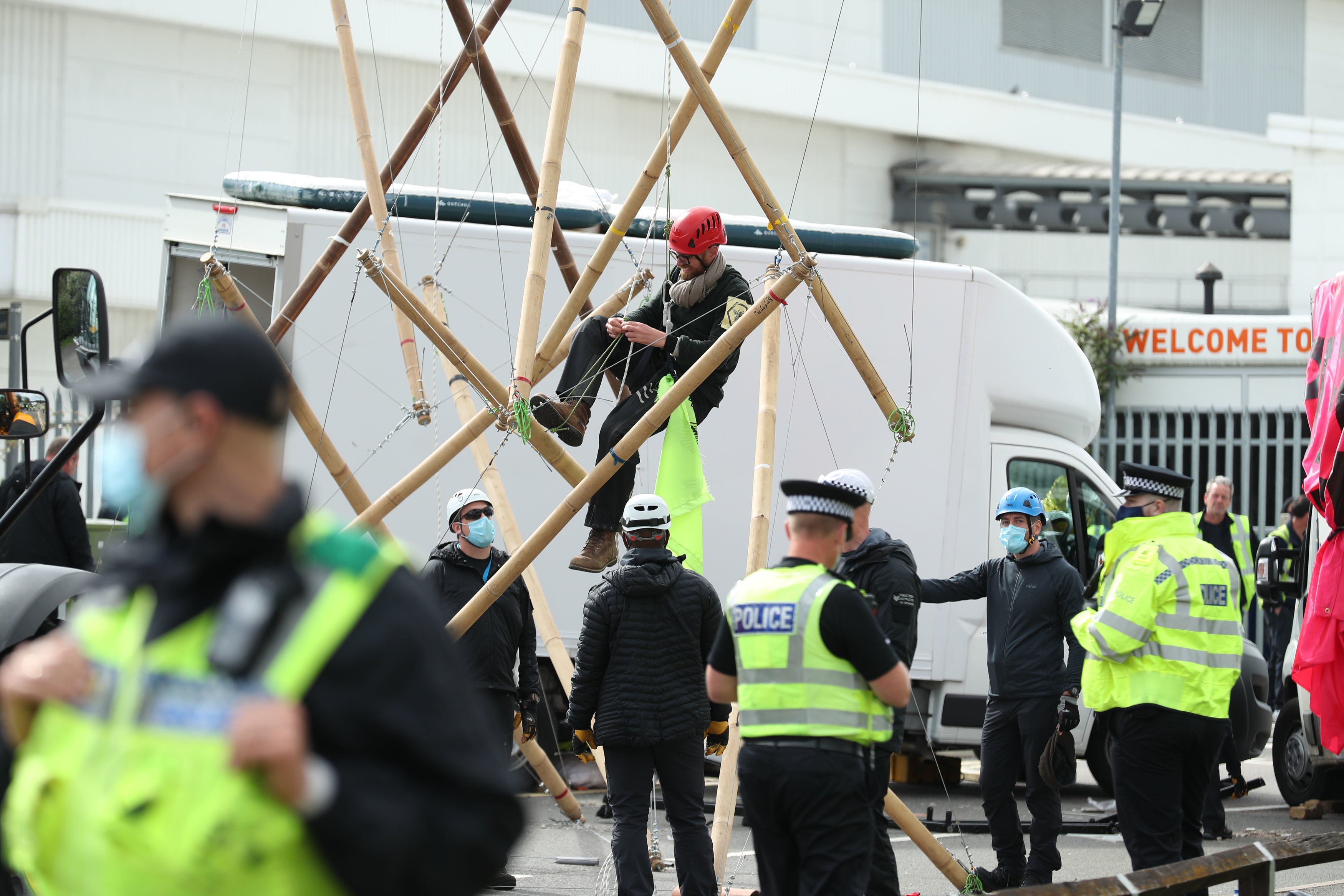 Two protesters use bamboo lock-ons to block the road outside the Newsprinters printing works at Broxbourne, Hertfordshire