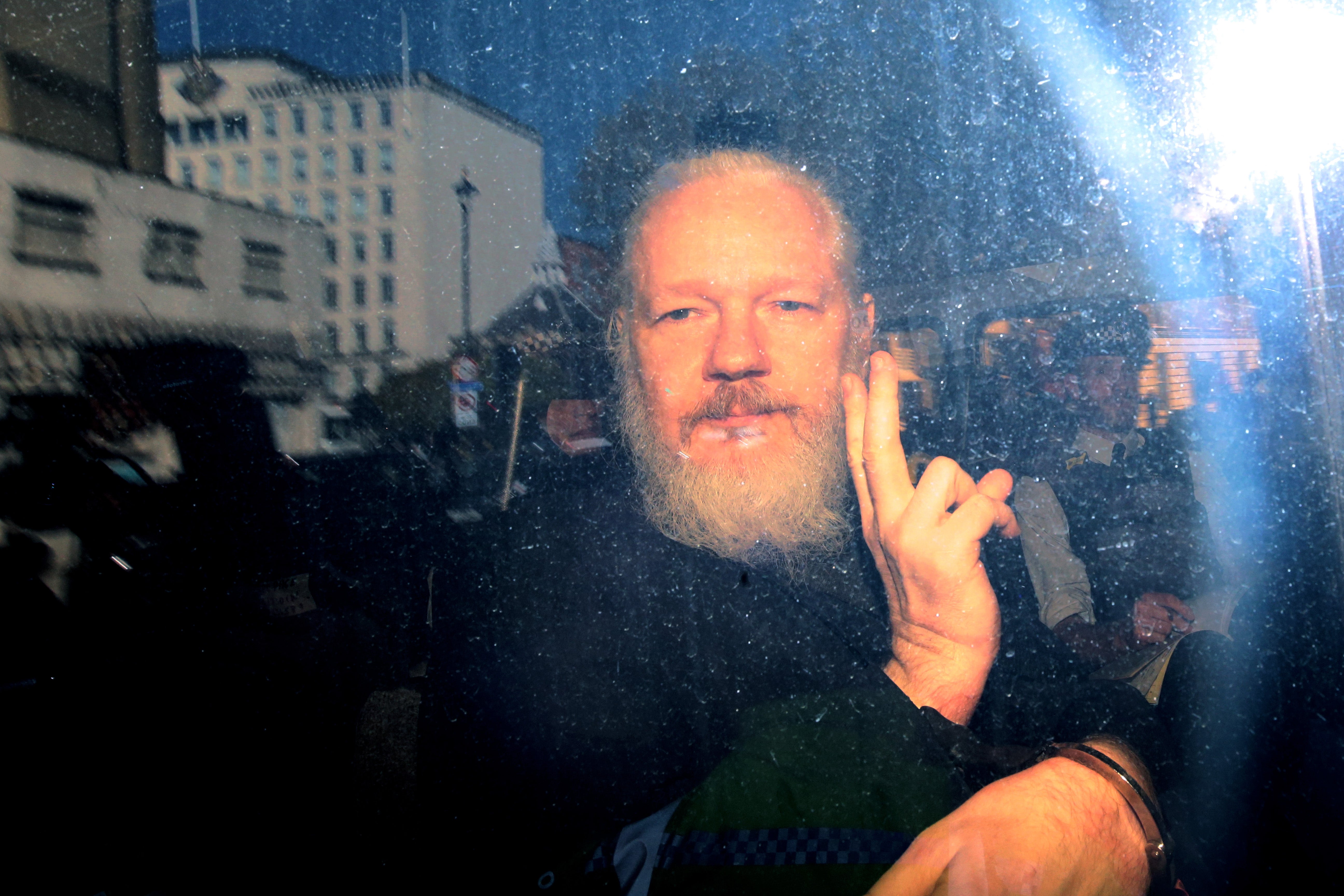 Julian Assange extradition hearing paused over fears lawyer exposed to coronavirus