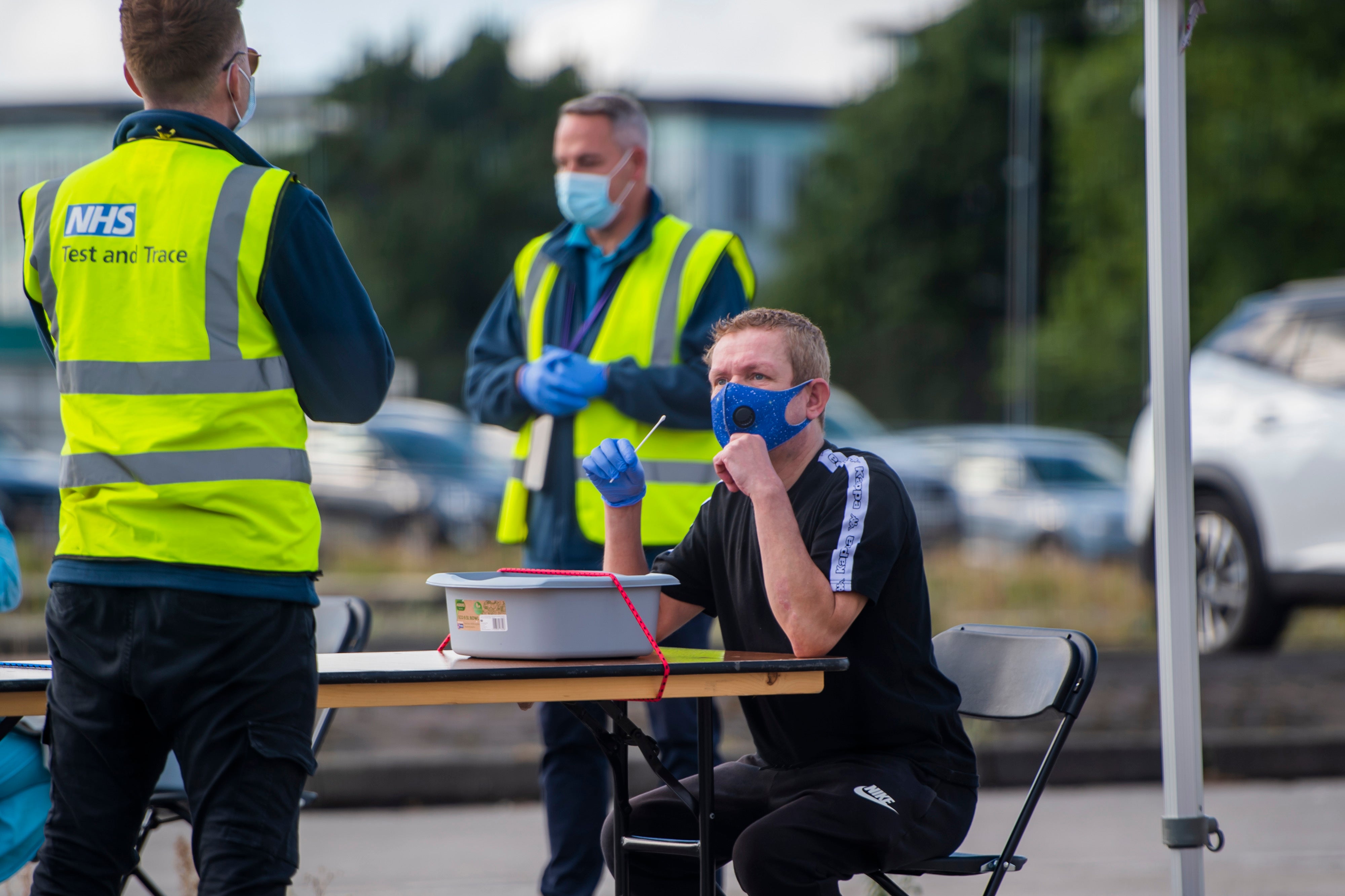 Members of the public attend a Covid-19 testing facility in Bolton