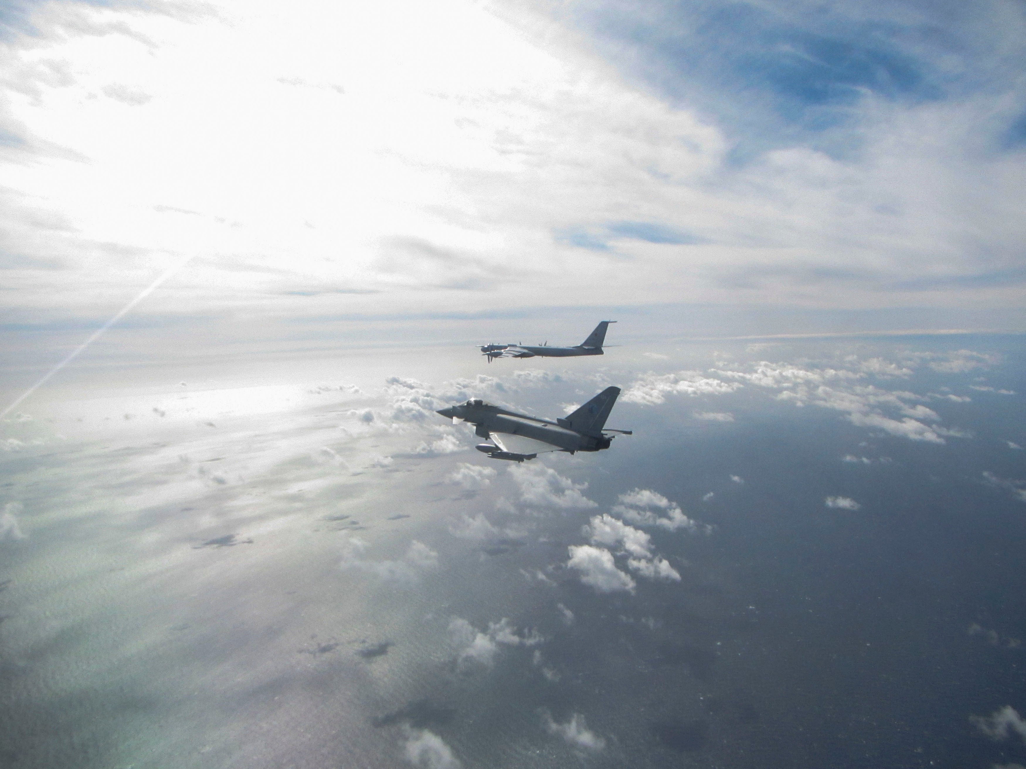 A photo issued by the MoD shows a Eurofighter Typhoon (near) and a Russian Bear F aircraft (far)