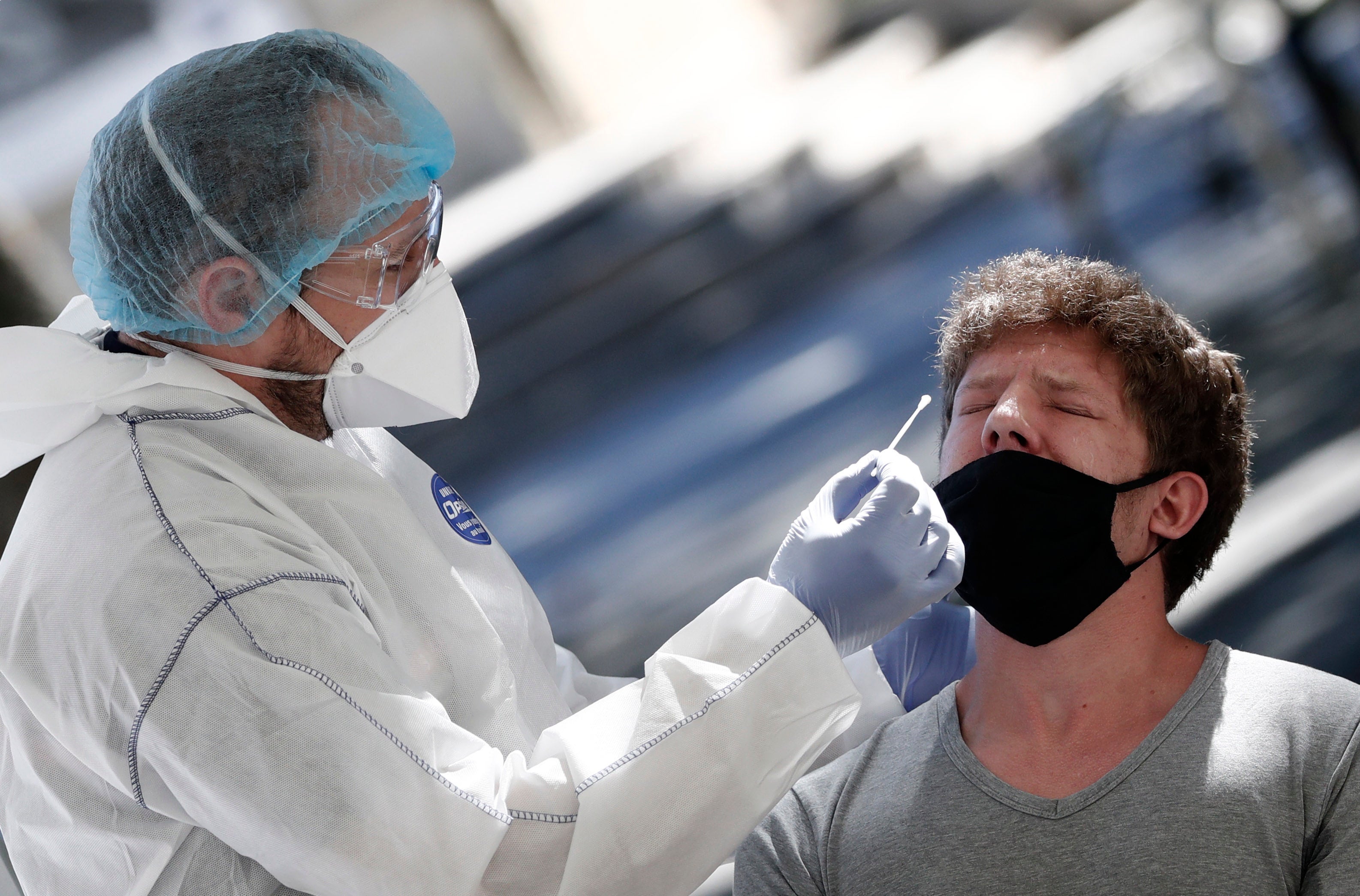 A medical worker takes a nose swab samples at a test station for Covid-19 coronavirus in Montpellier, France