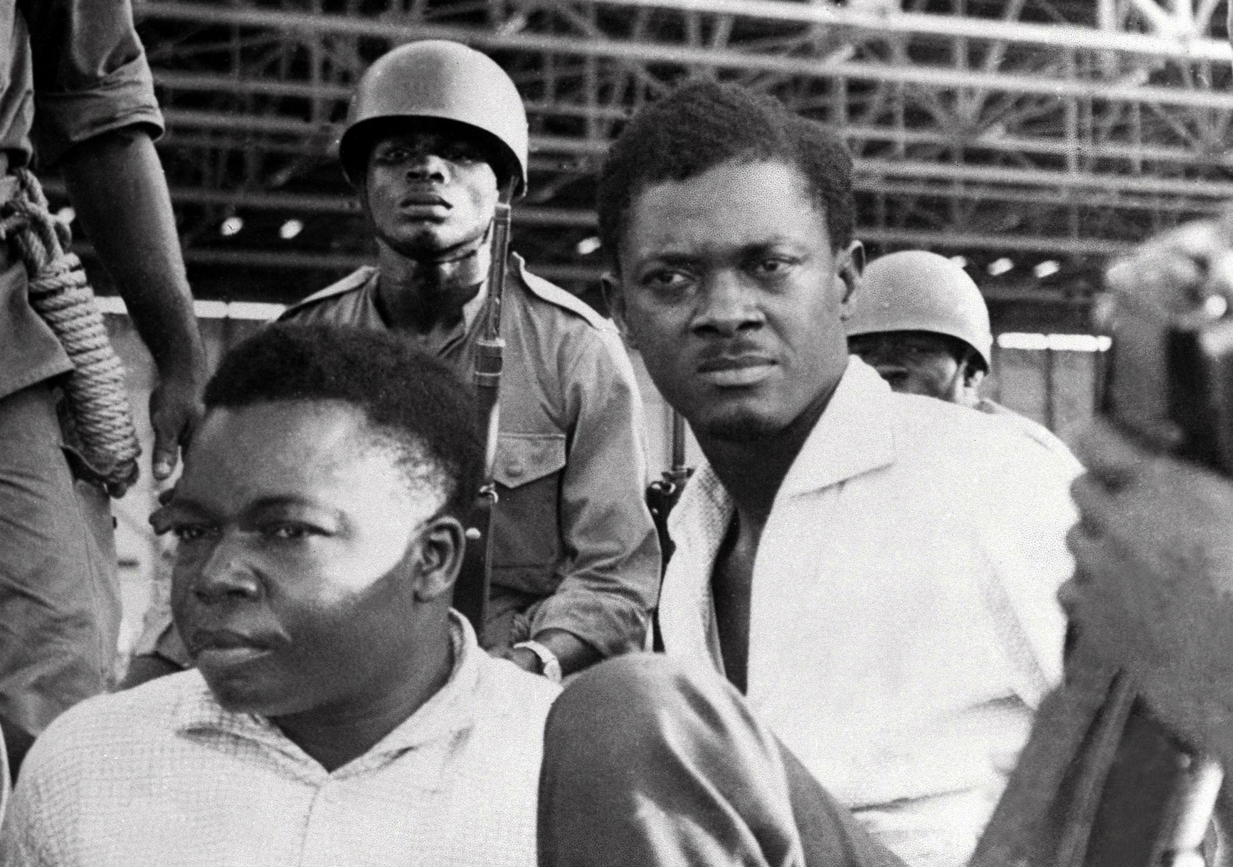 Soldiers guarding Patrice Lumumba (right) and Joseph Okito (left) upon their arrest in Leopoldville in 1960