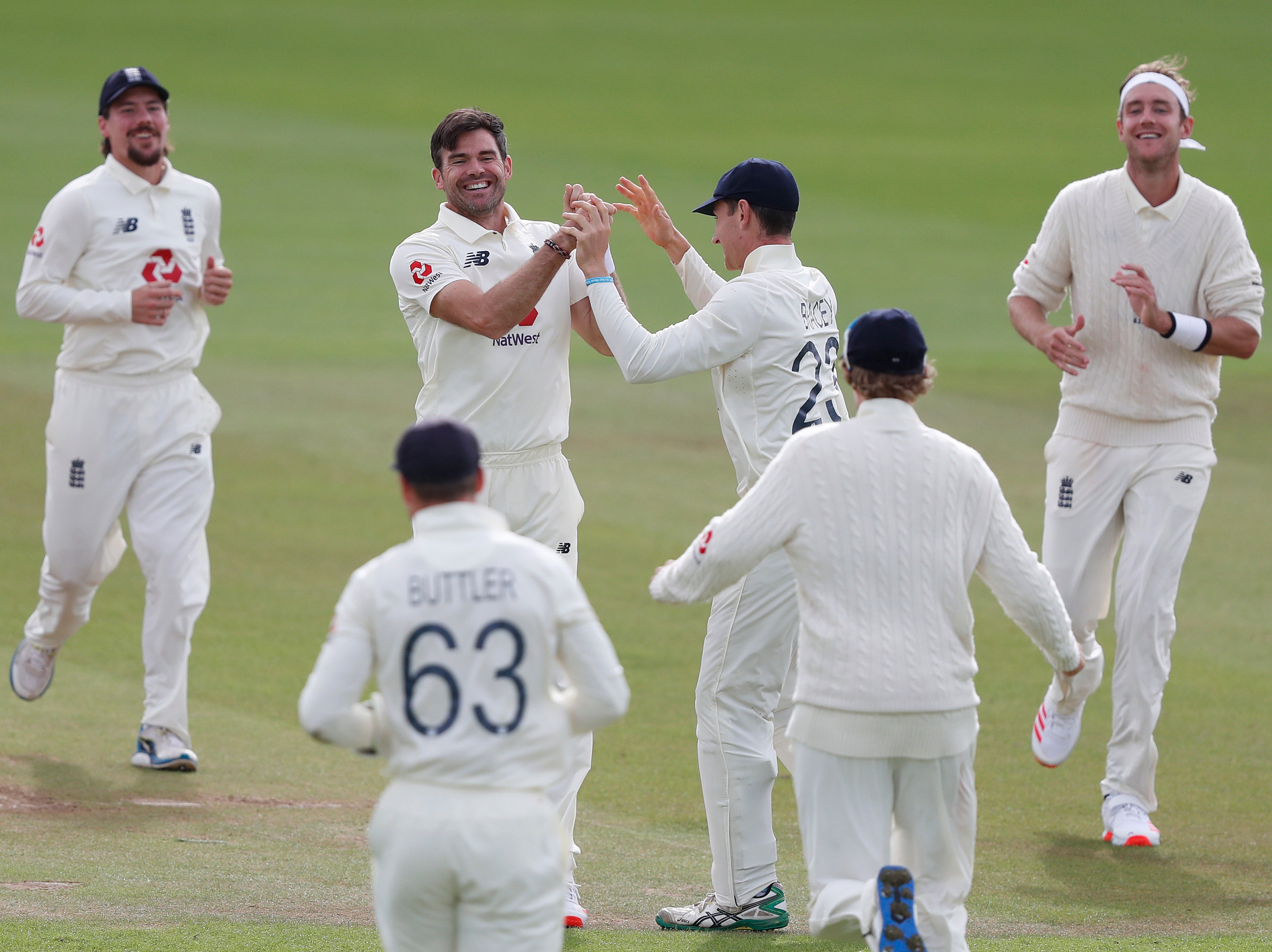 James Anderson (centre left) and Stuart Broad (right) achieved milestones this summer