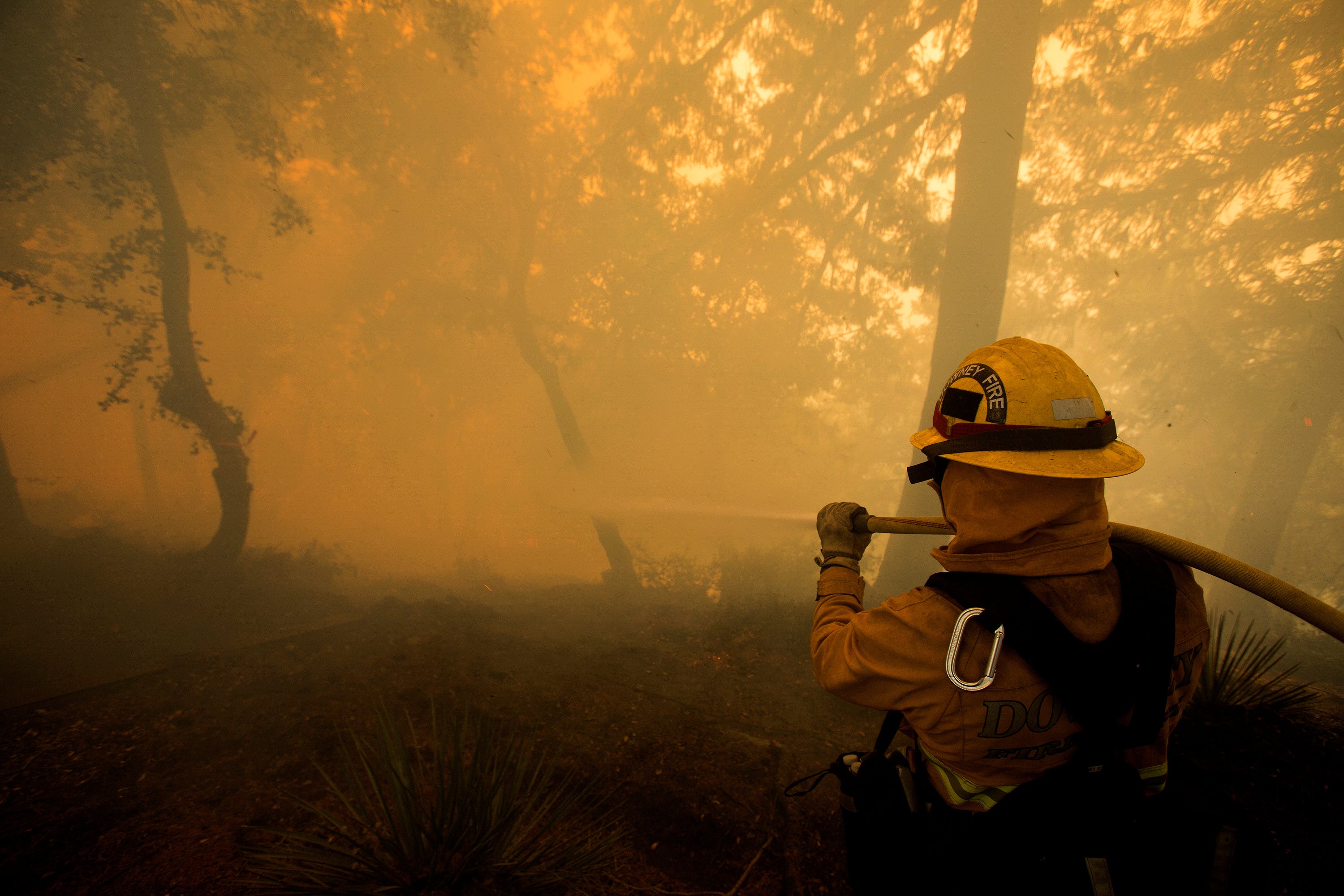 A firefighter battles a wildfire near a structure while defending the Mount Wilson observatory during the Bobcat Fire in Los Angeles, California