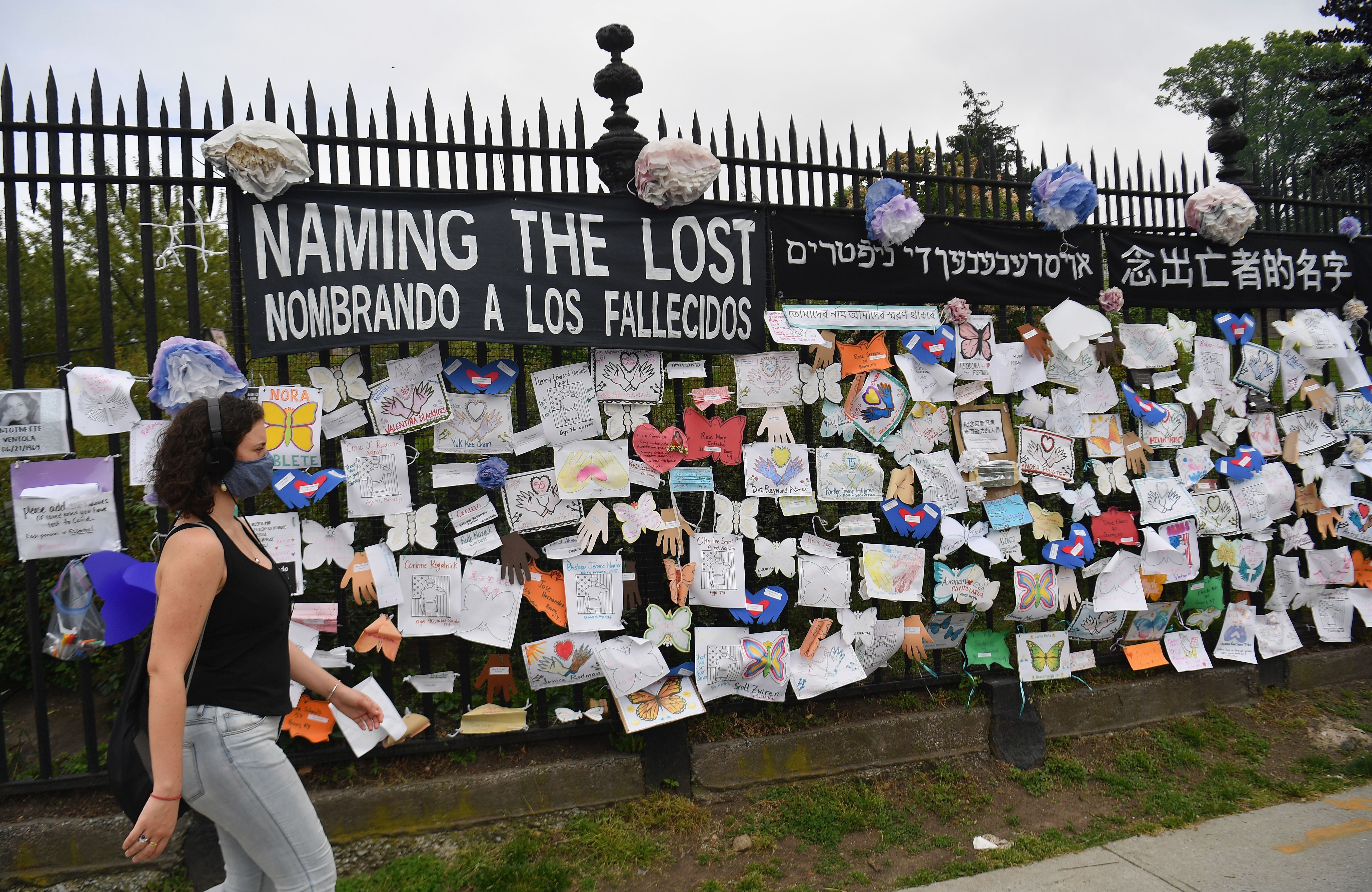 A woman walks past a memorial to those who lost their lives to Covid-19 in New York City in May, 2020