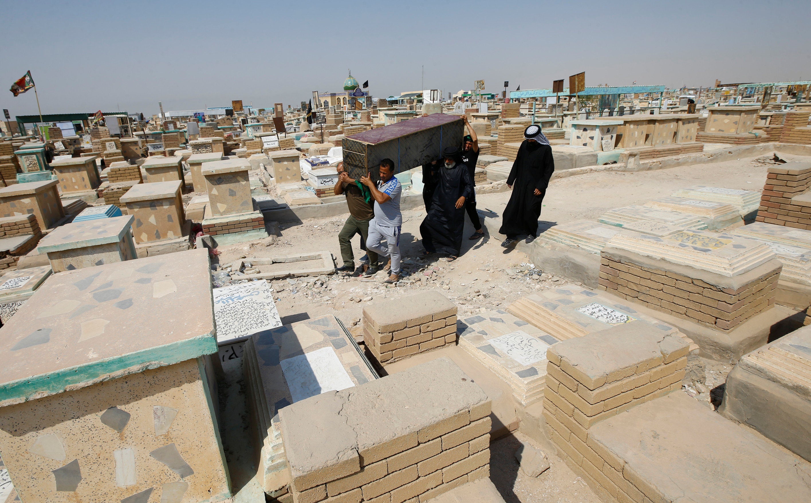 Iraqis flock to Najaf’s Covid-19 cemetery to move their dead elsewhere