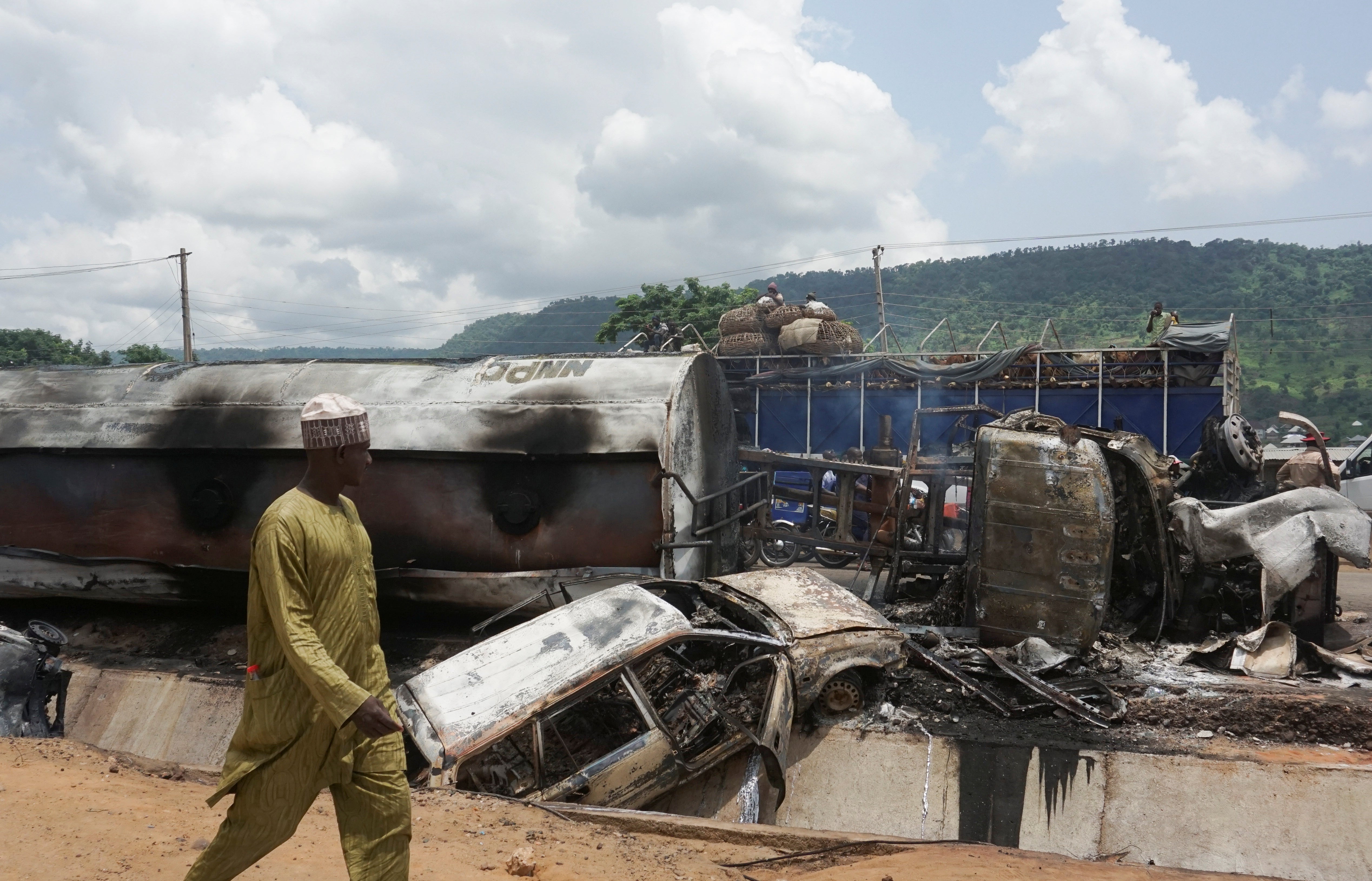 A man inspects the damage at the site of a gas tanker explosion in the central Nigerian state of Kogi