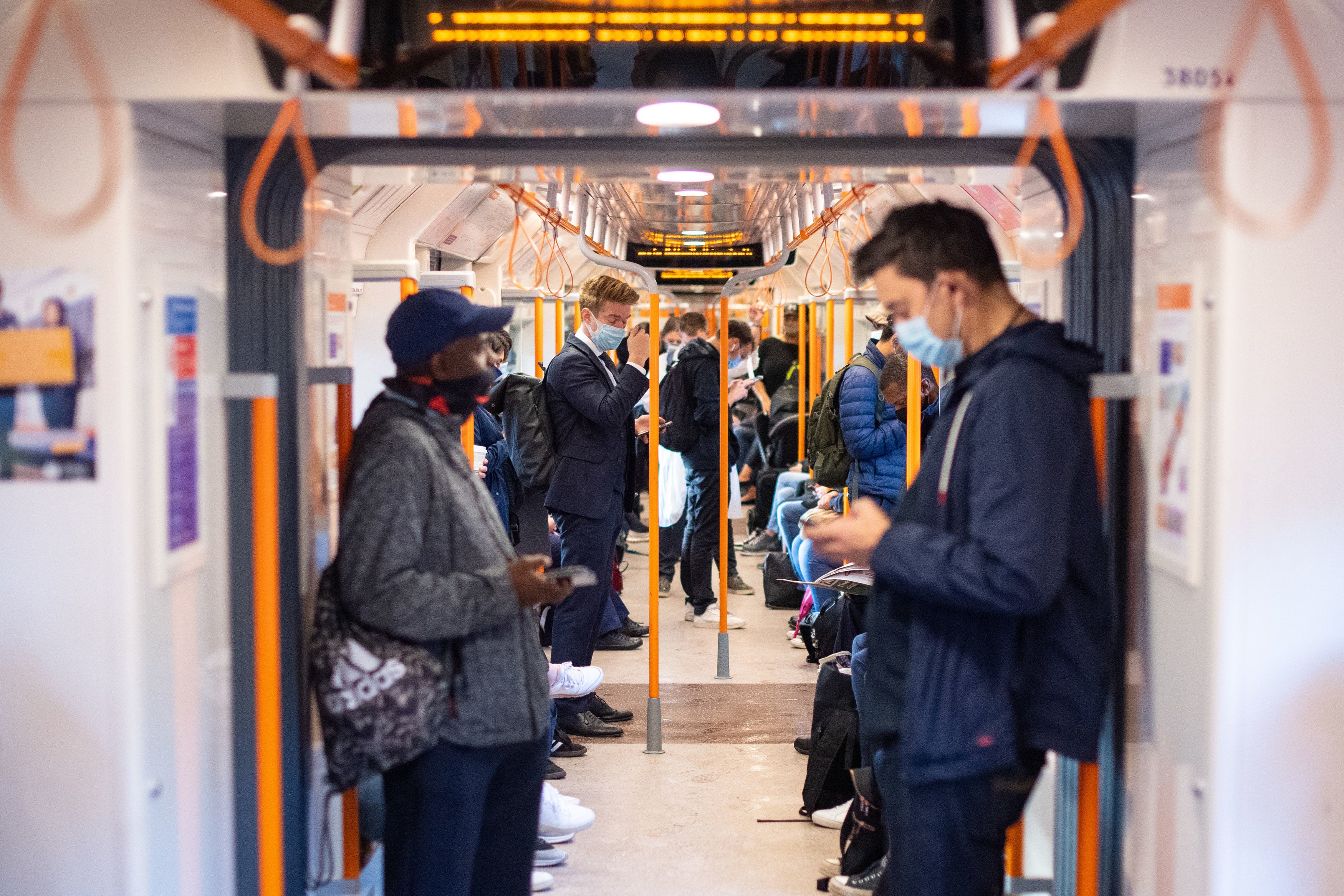 Commuters on board a London Overground train following social distancing during restrictions to combat the fresh rise in coronavirus cases in England