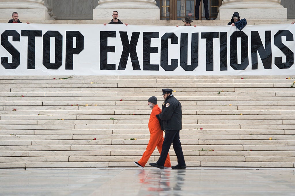 Randy Gardner is removed by police while wearing his executed brother's prison jumpsuit during a protest against the death penalty at the US Supreme Court