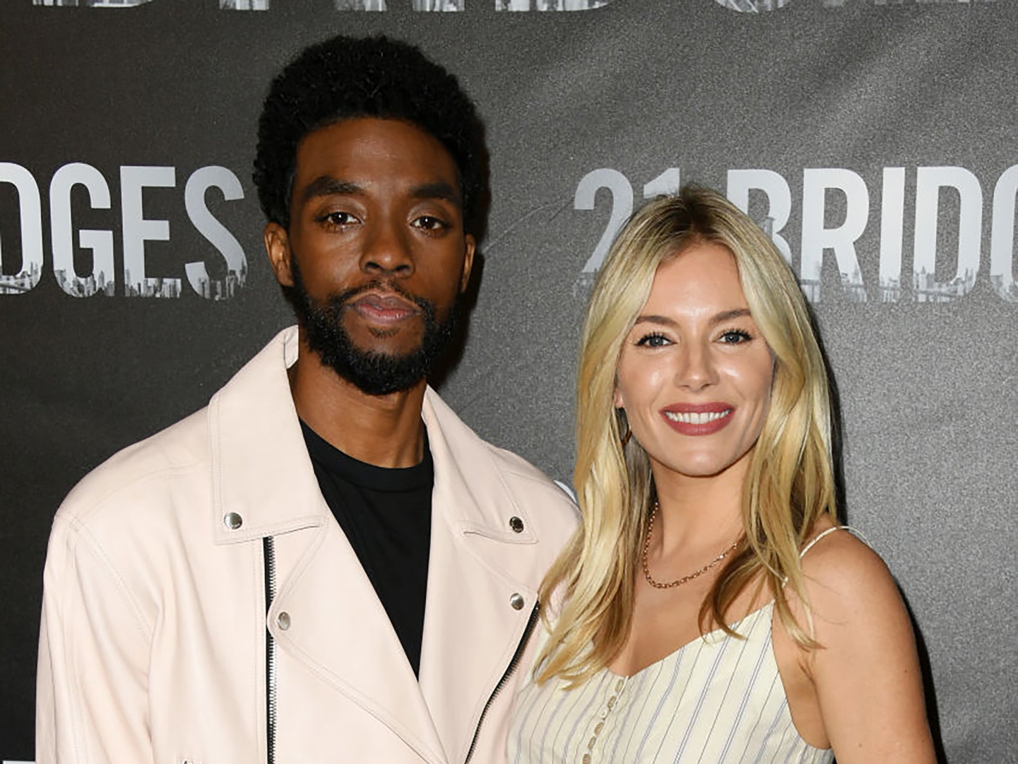 Chadwick Boseman and Sienna Miller at a ‘21 Bridges’ premiere in November 2019