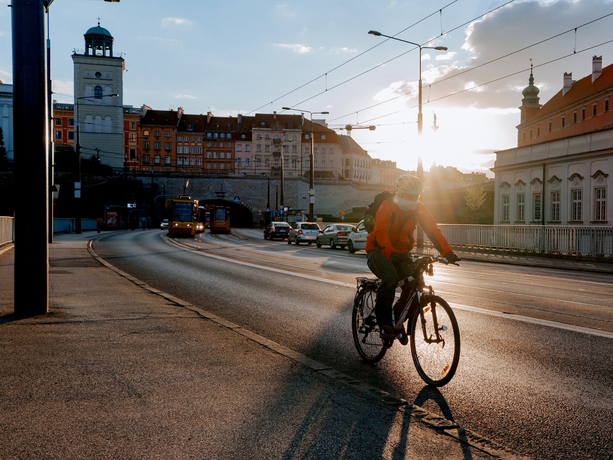 *description*Man rides bike on Aleja Solidarnosci in oWarsaw