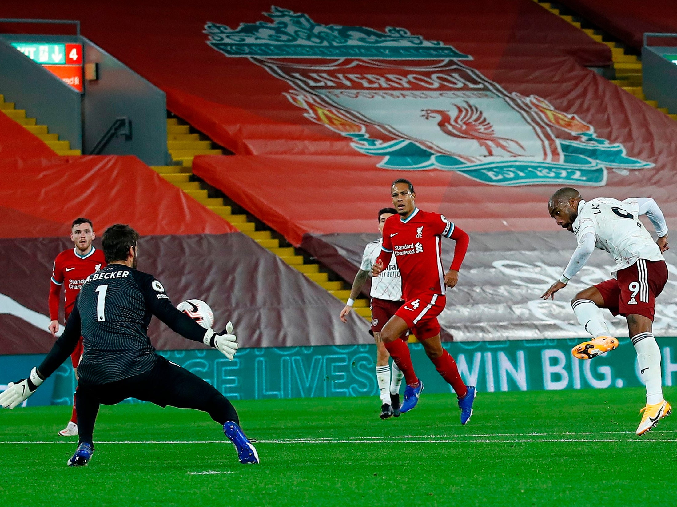 Alisson Becker saves from Alexandre Lacazette