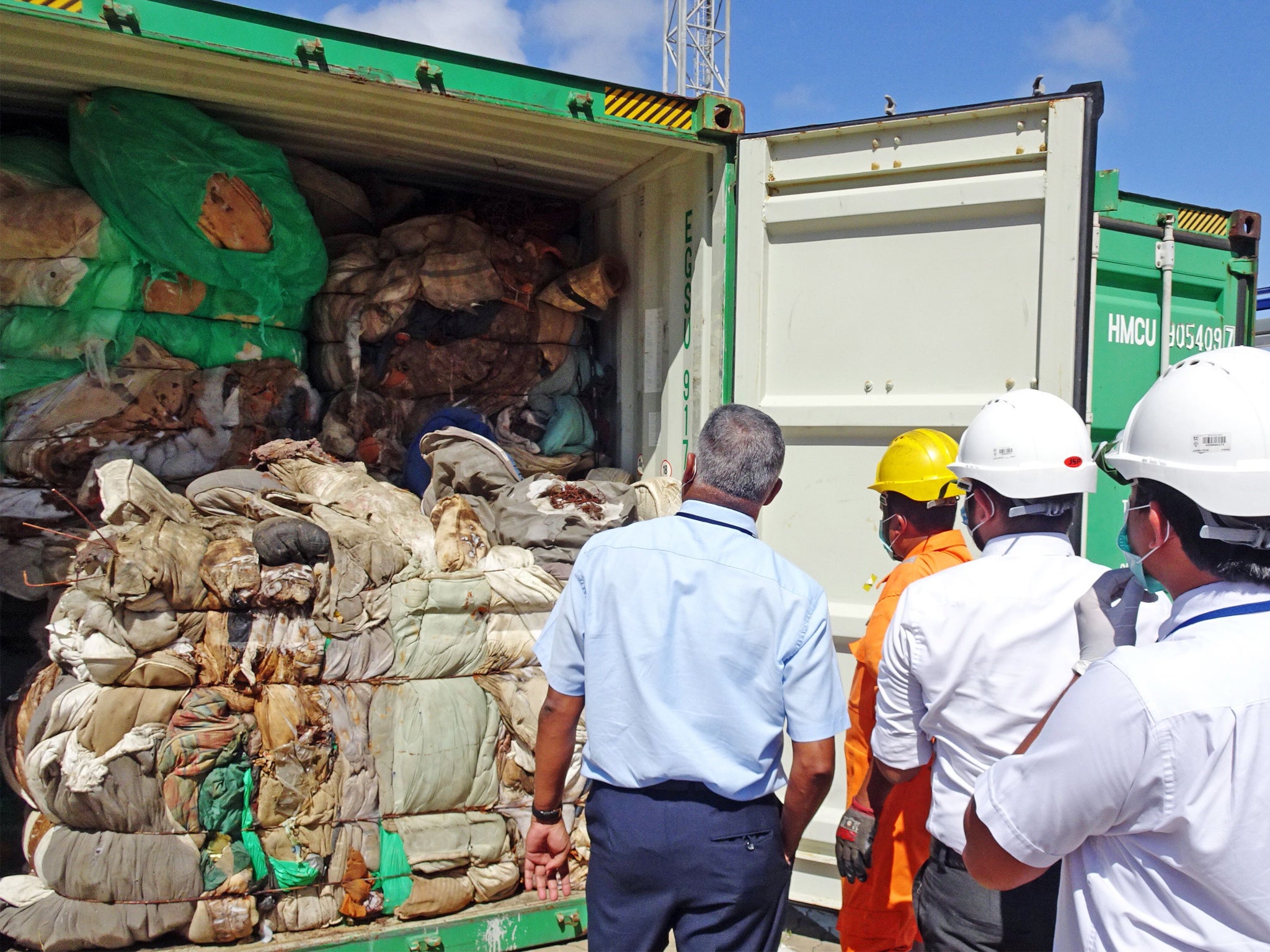 Customs officials inspect container at Colombo port in 2019 following similar incident of hazardous clinical waste entering the country