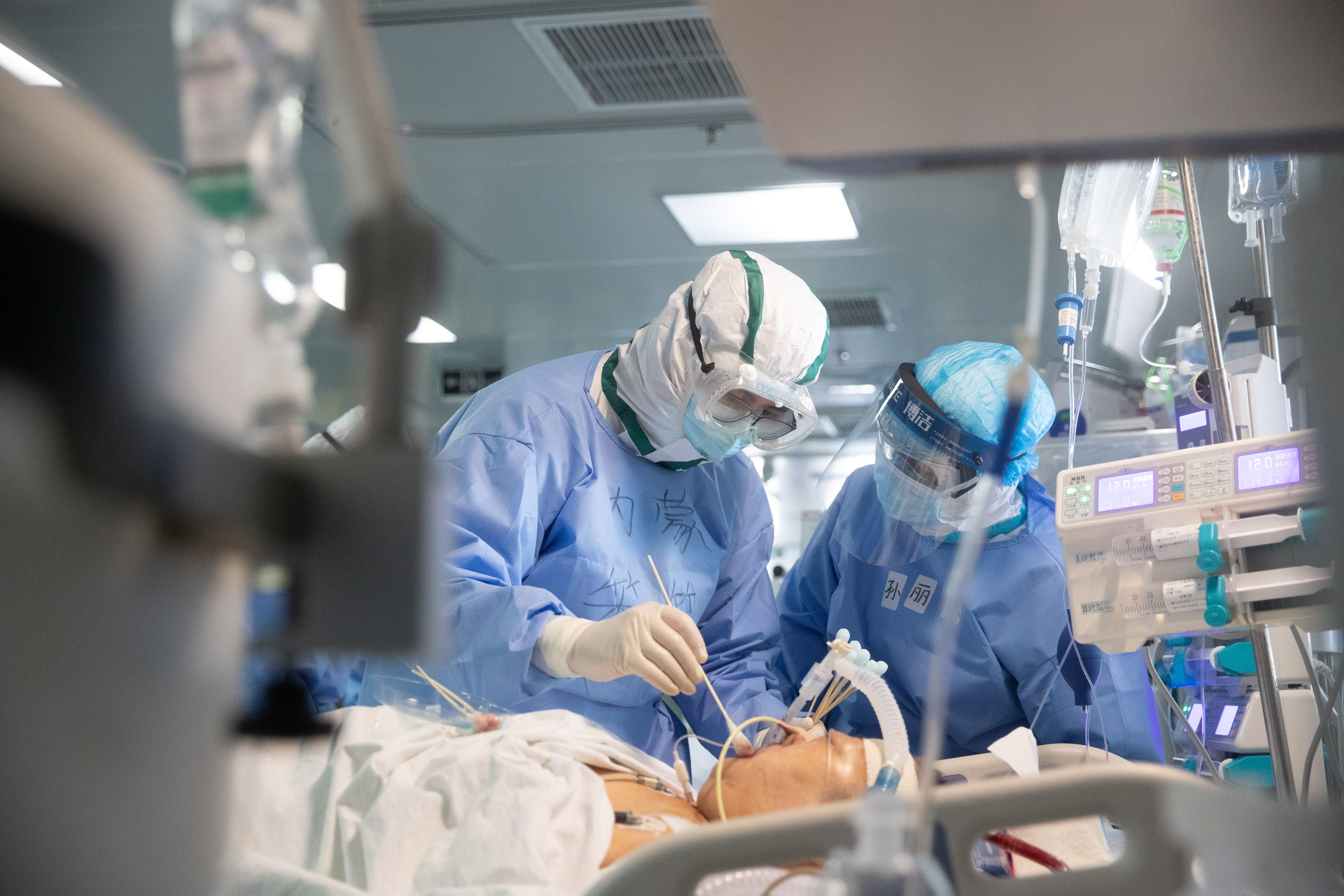 Doctors treat a Covid-19 patient in a hospital in Wuhan