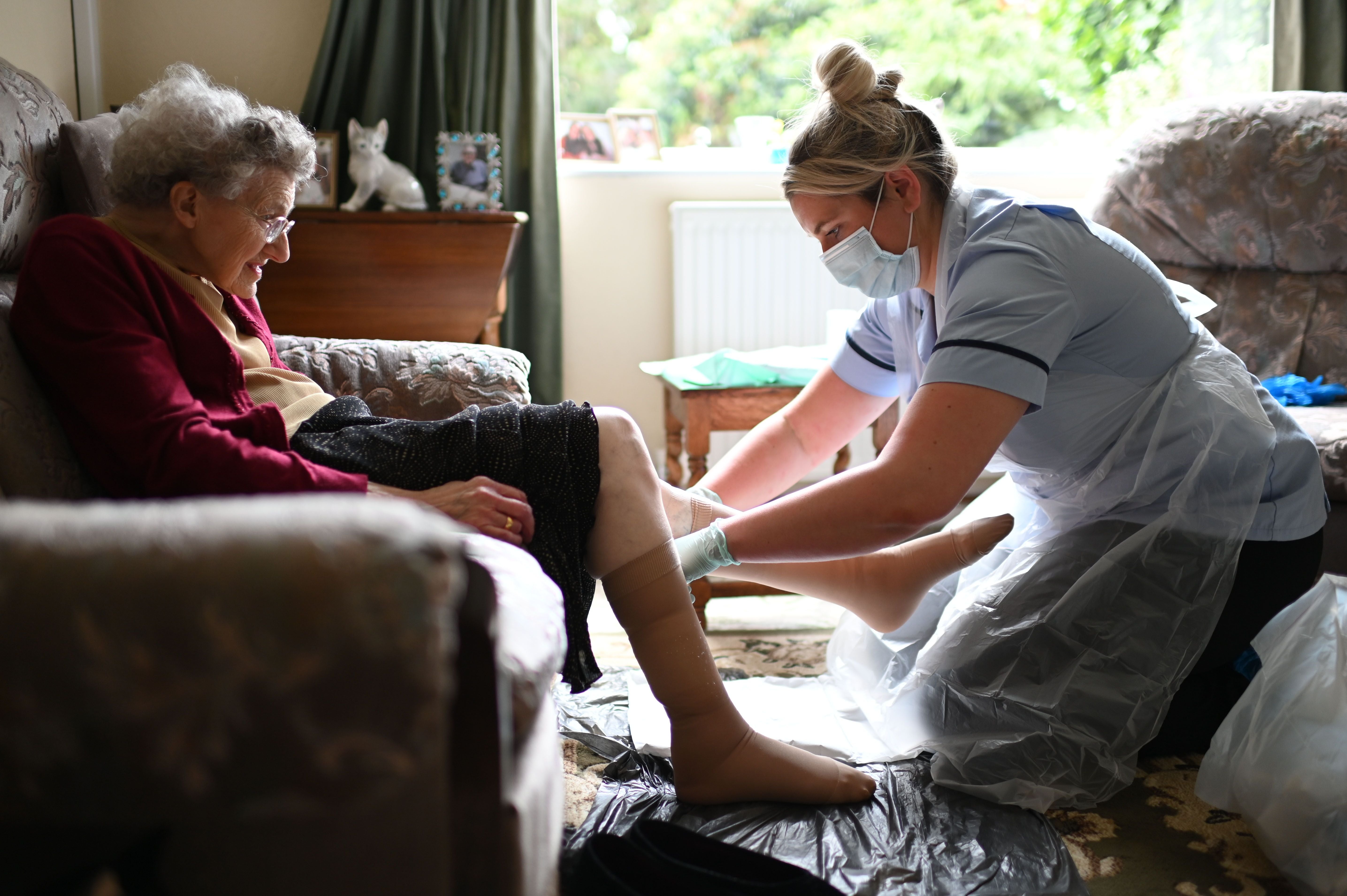 District nurse Rebecca McKenzie changes the dressings on Margaret Ashton’s legs to treat ulcers