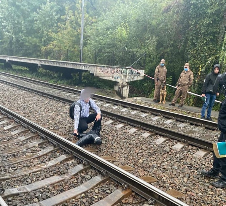 Ukraine authorities investigate the scene where a US Embassy worker was found near train tracks in Kiev's Nyvky Park