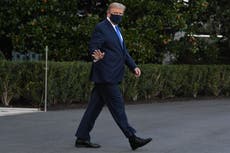 Masked Trump waves to well-wishers as he walks to helicopter to be airlifted to Walter Reed