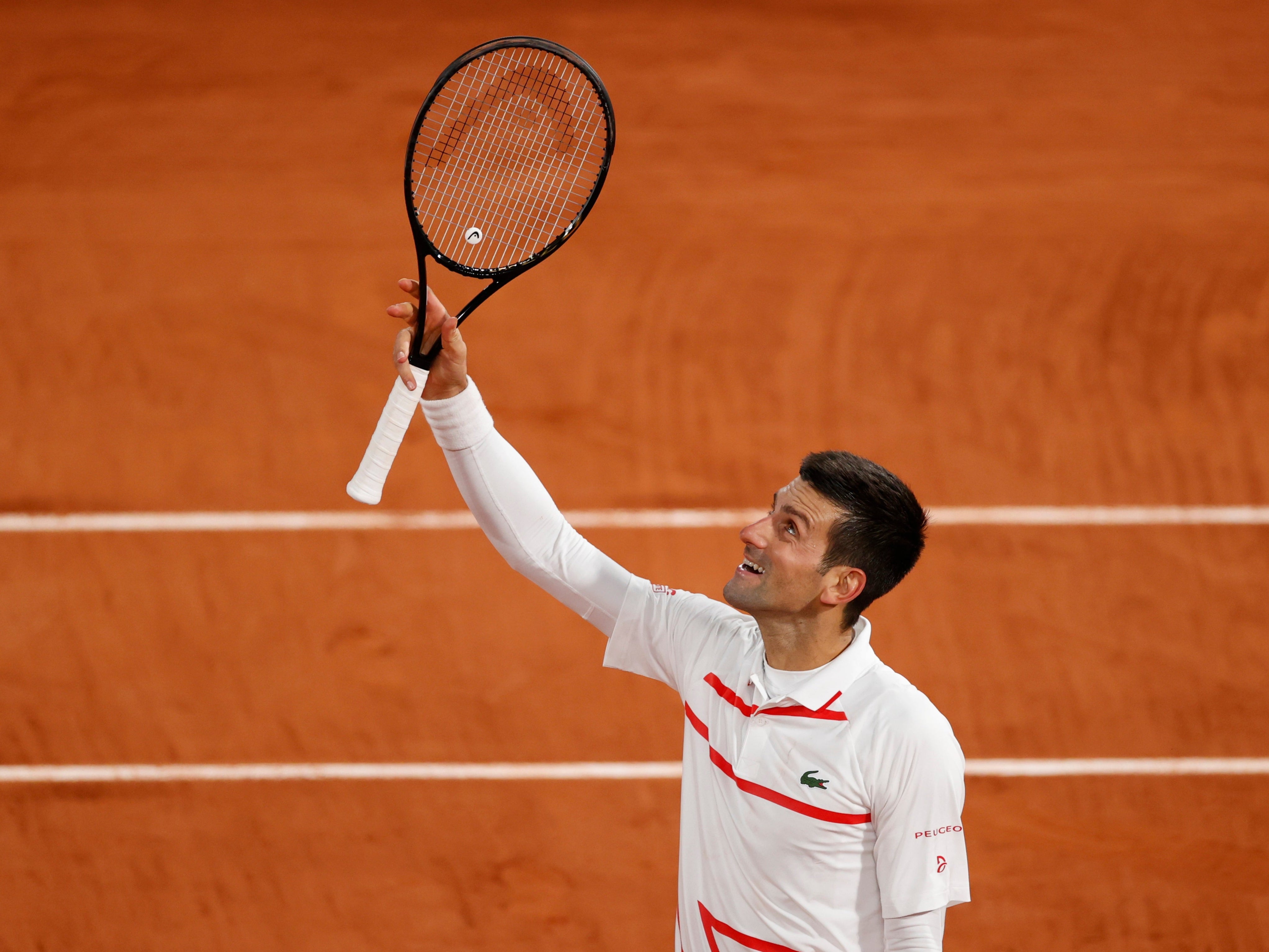 Novak Djokovic celebrates reaching the fourth round