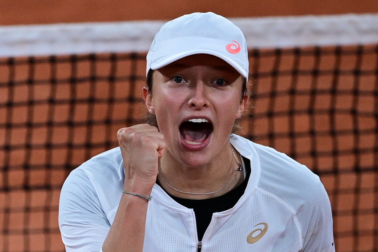 Iga Swiatek celebrates her shock victory over French Open top seed Simona Halep