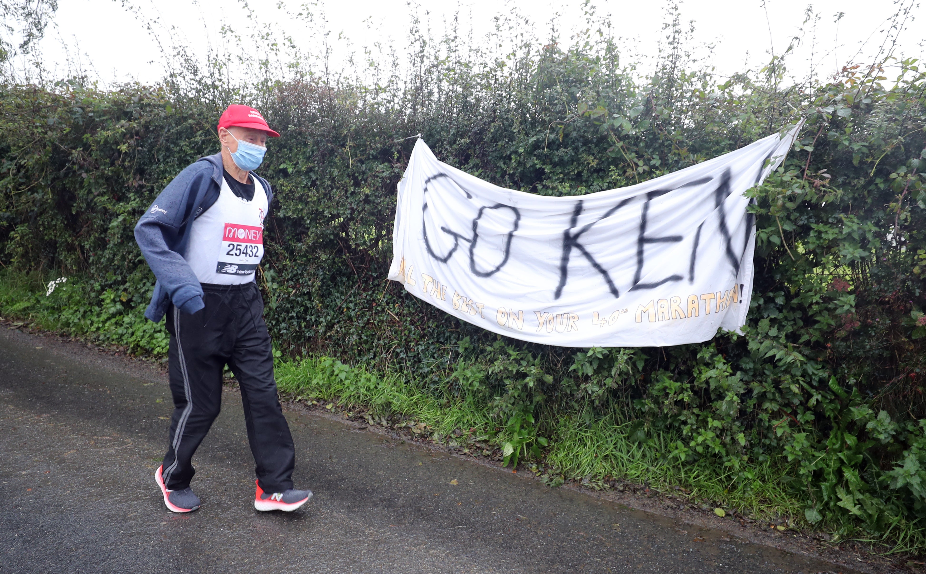 Ken Jones, 87, takes part in the historic first virtual London Marathon during gale-force winds and rain in his home town of Strabane, west Tyrone