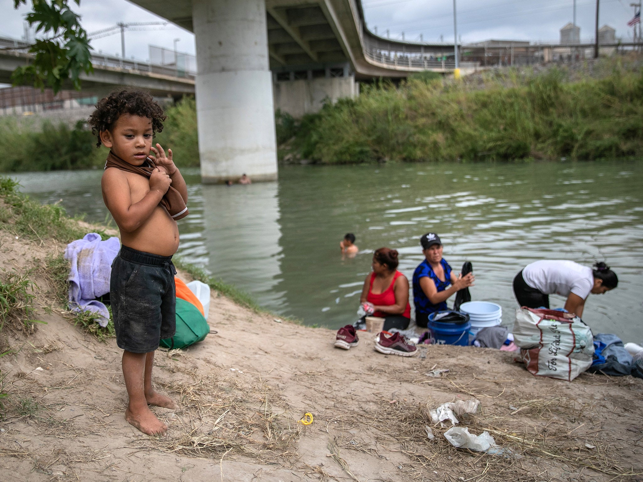 Asylum seekers wash clothes in river by Matamoros camp on 8 Dec 2019 - At least 50 percent of the asylum seekers still waiting at the camp are children under the age of 15