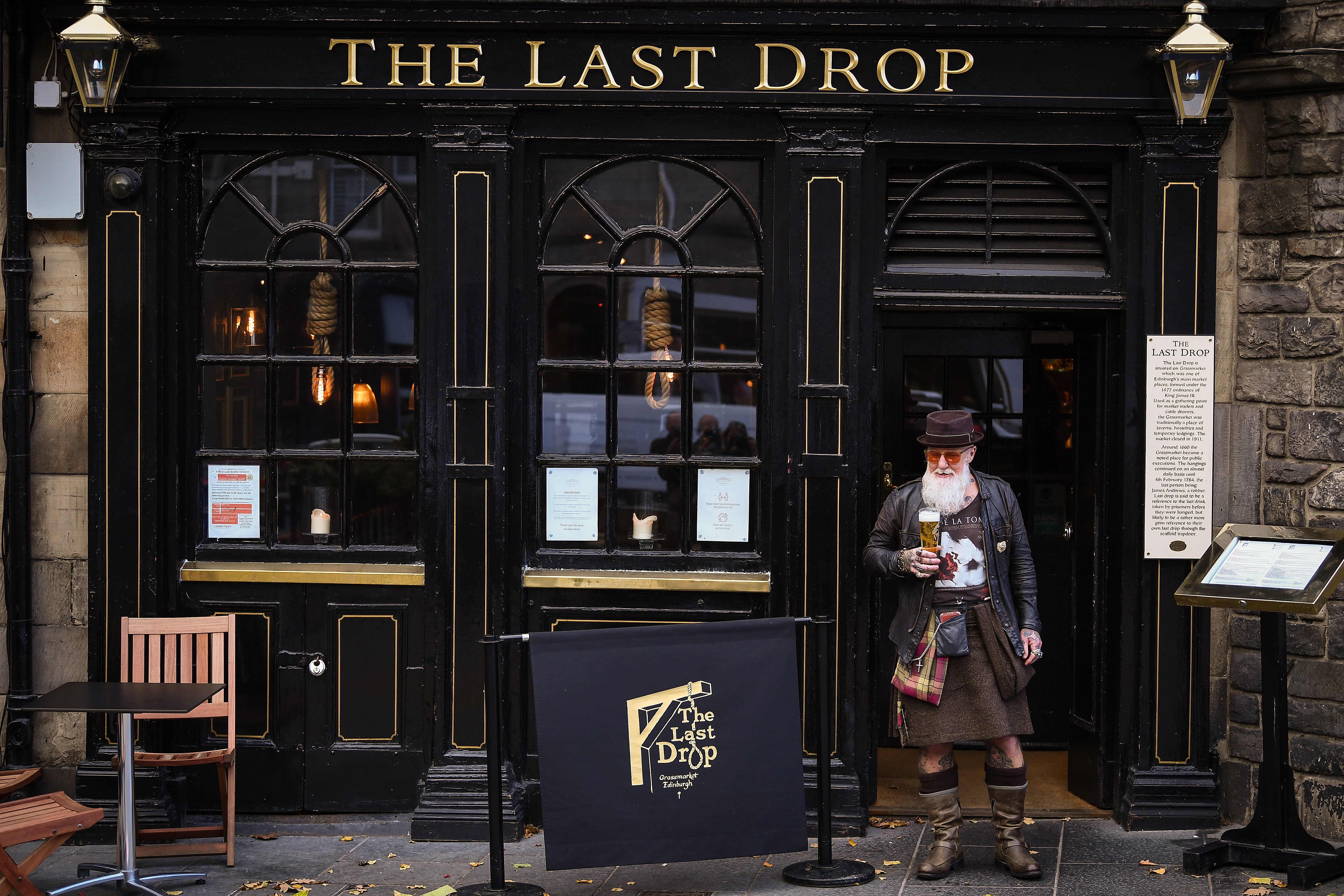 Charles Douglas Barr enjoys a pint outside The Last Drop pub in the Grassmarket, Edinburgh