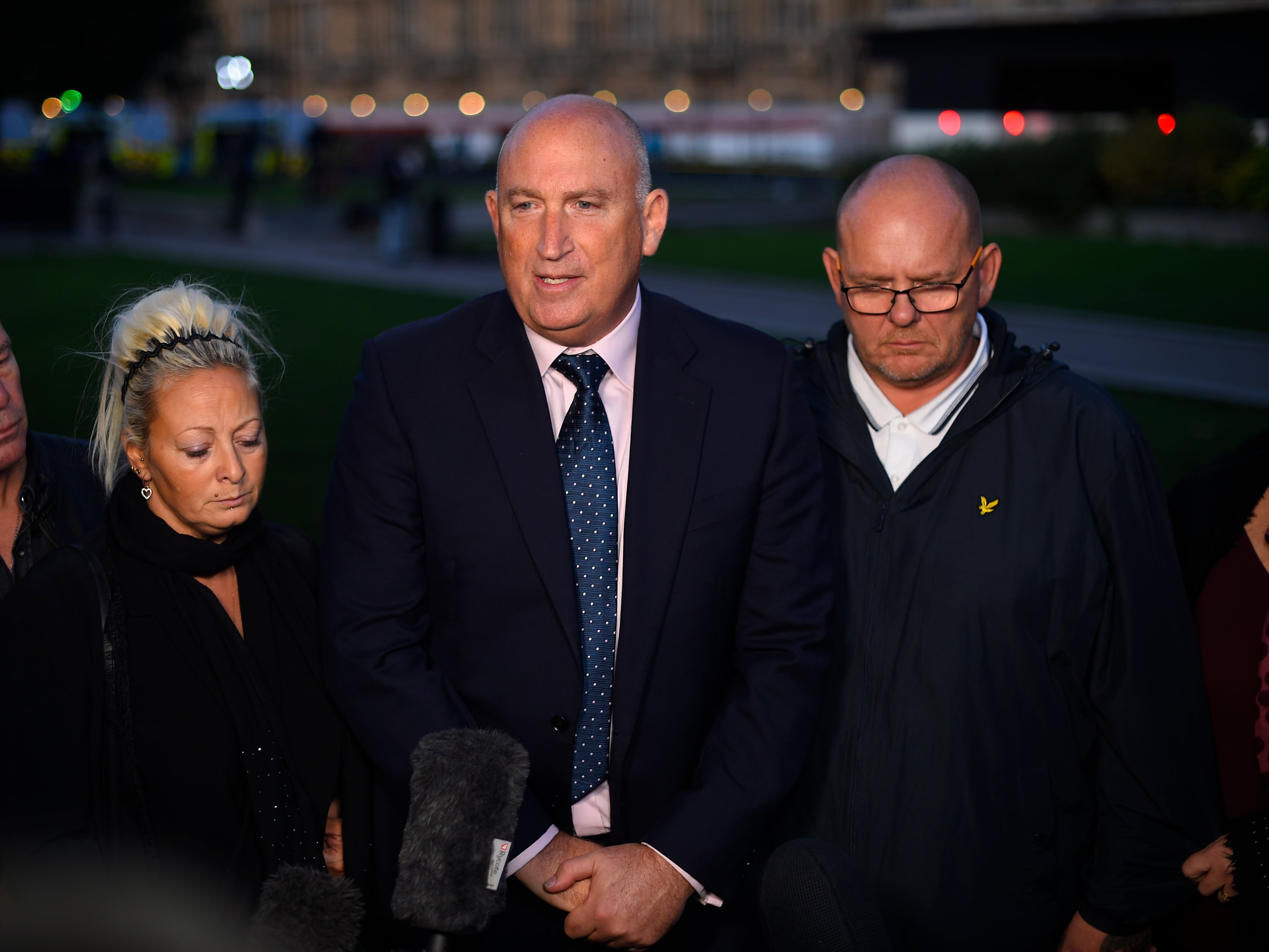 The parents of Harry Dunn, Charlotte Charles and Tim Dunn, pictured with family spokesman Radd Seiger (centre).