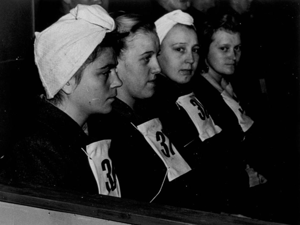 Four female guards photographed in the dock during the Belsen trial for concentration camp atrocities, in Luneburg