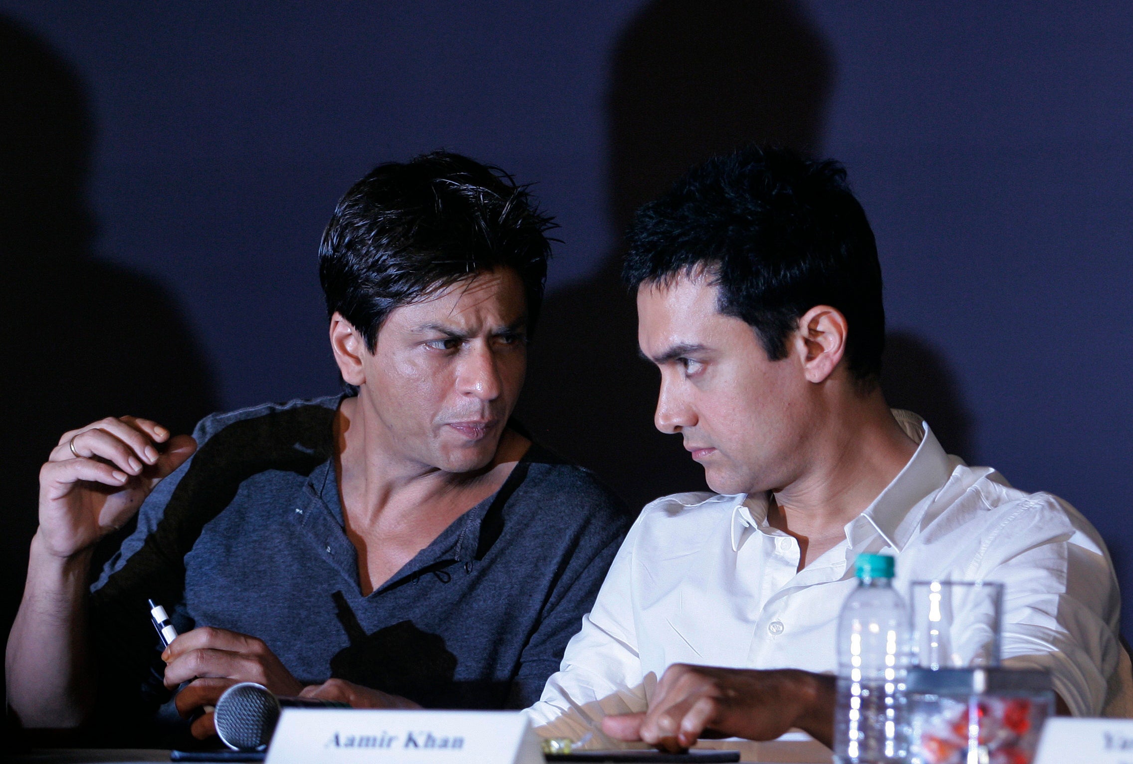 In this April 7, 2009, file photo, Bollywood actors Shah Rukh Khan, left, and Aamir Khan speak during a press conference in Mumbai