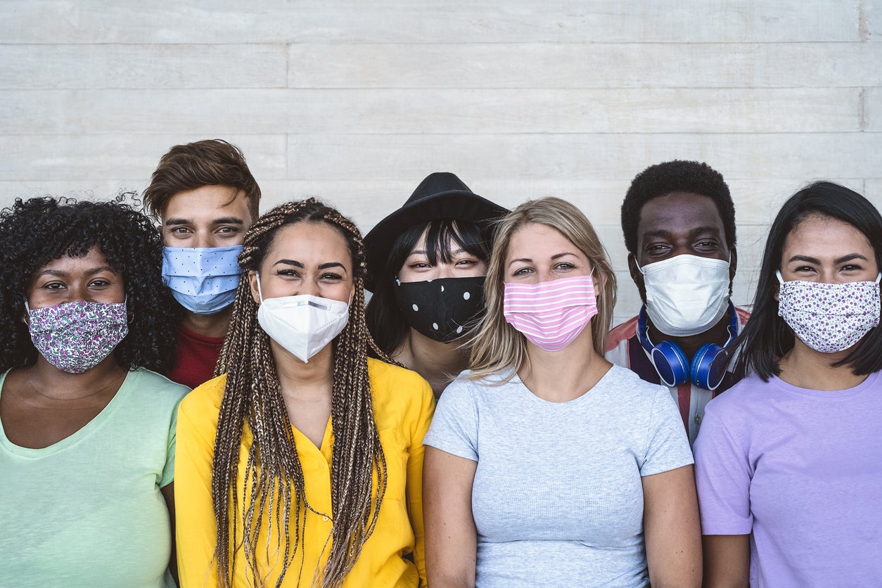 Smiling at others behind your mask can have an effect on your mood