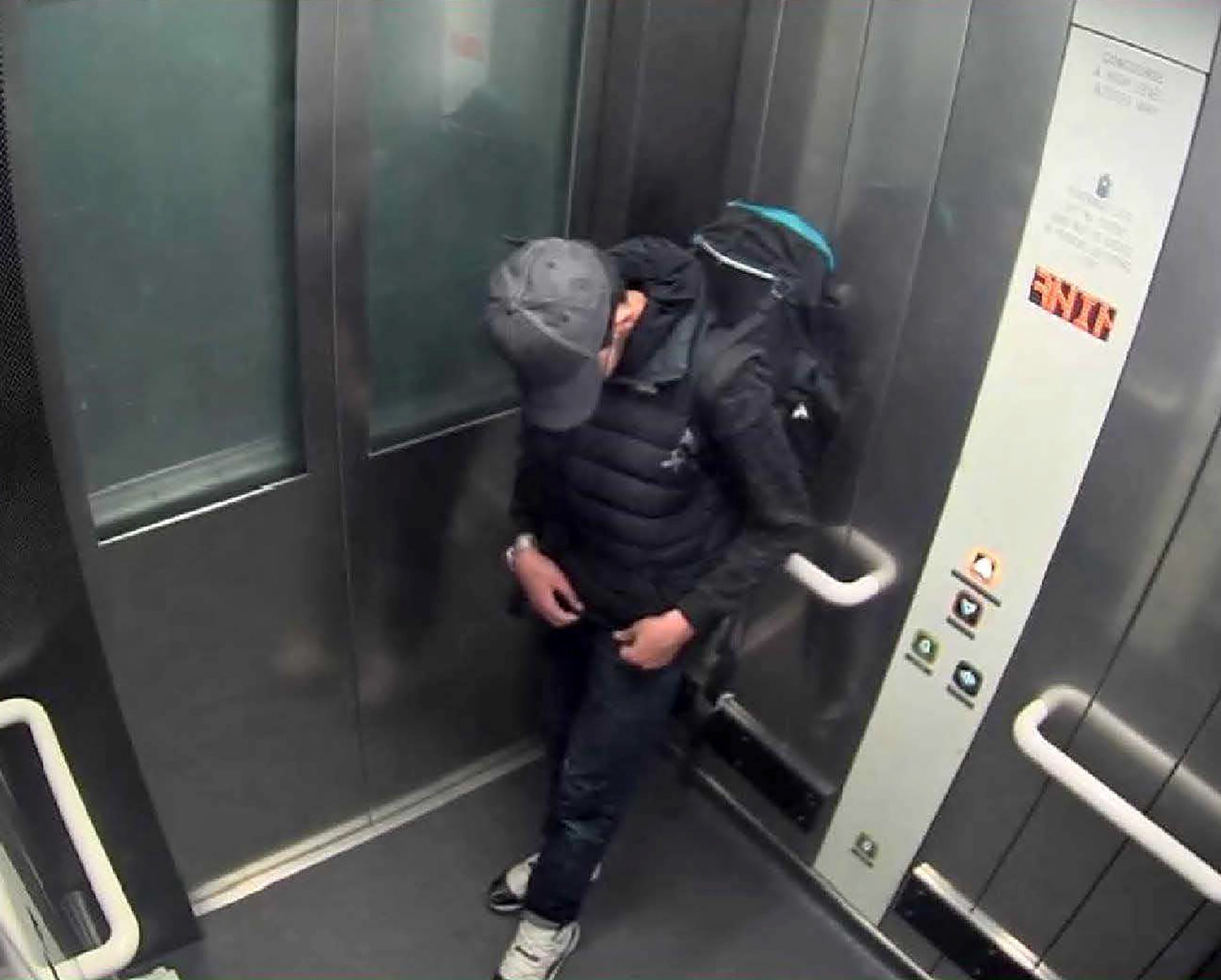 Salman Abedi adjusting wiring underneath his clothing as he carries his suicide bomb in a lift at Manchester Arena shortly before the attack on 22 May 2017