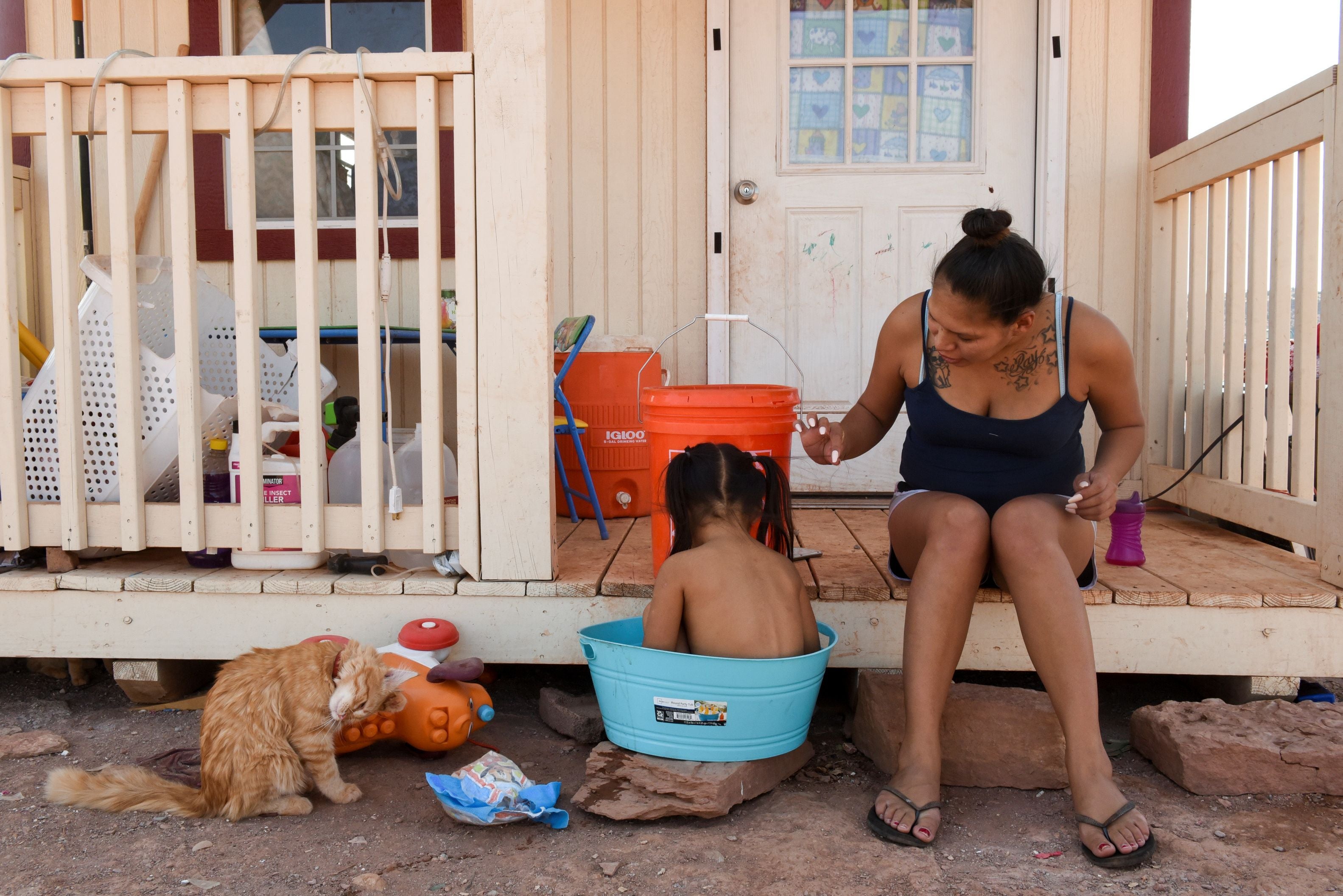 Summer Weeks bathes her daughter Ravynn, 2