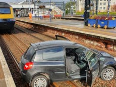 Two people in hospital after cars land on rail lines in Scotland