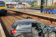 Two people in hospital after cars land on rail lines in Scotland