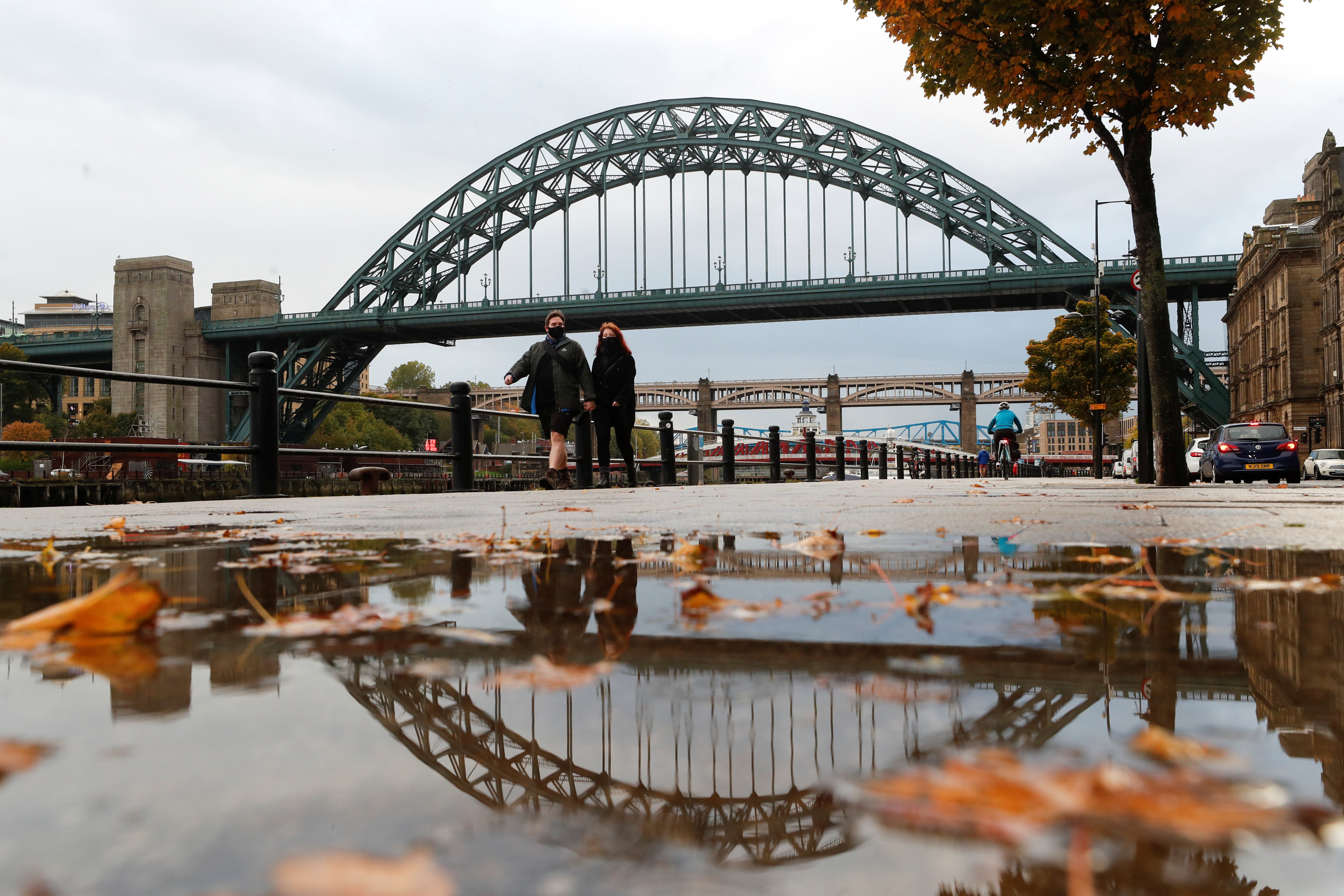 People in Newcastle wear protective face coverings