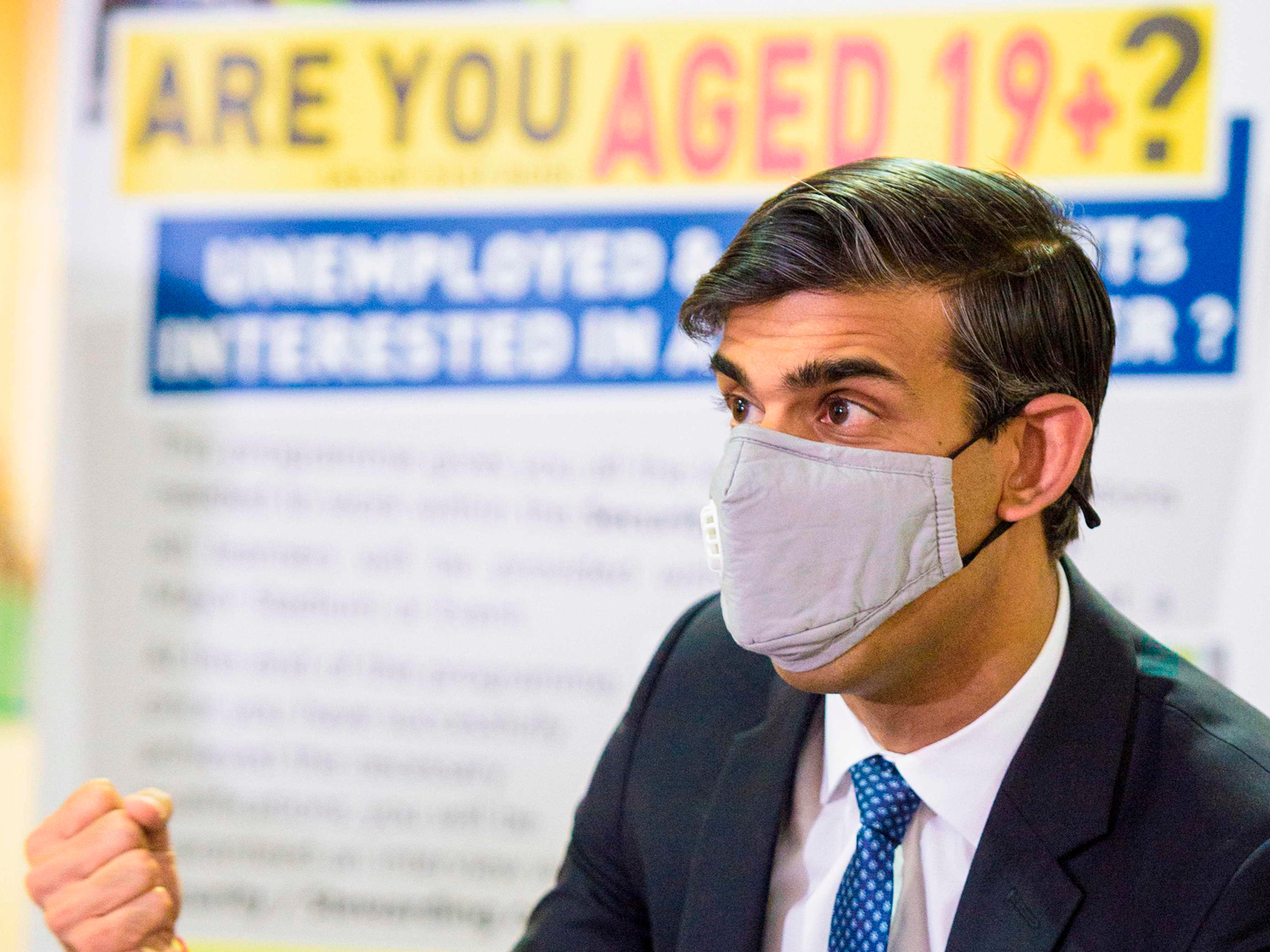 Rishi Sunak talks with staff as he visits a Jobcentre Plus in Barking, east London