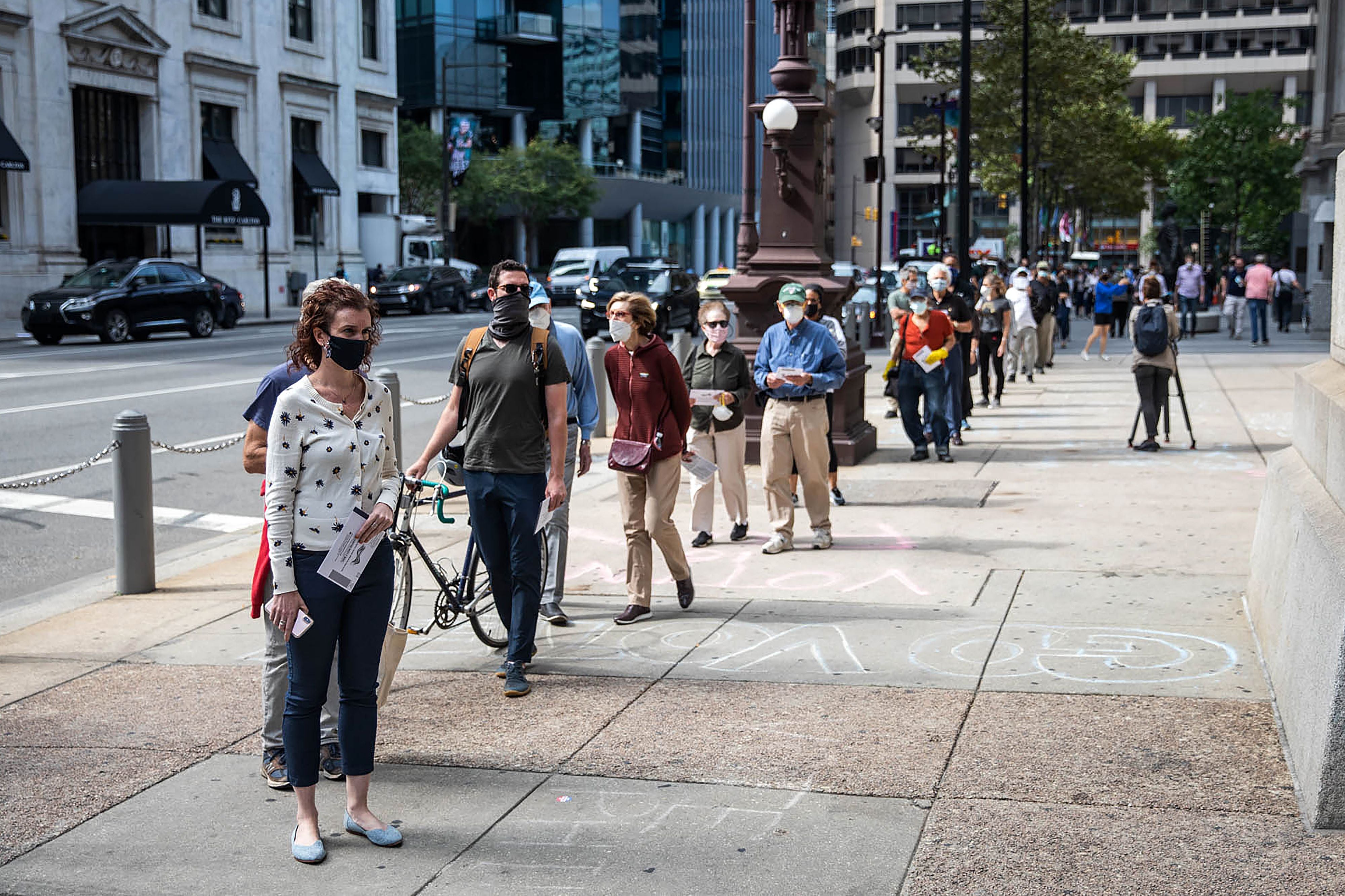 People wait in line to cast their vote during early voting at City Hall in Philadelphia, Pennsylvania on 7 October