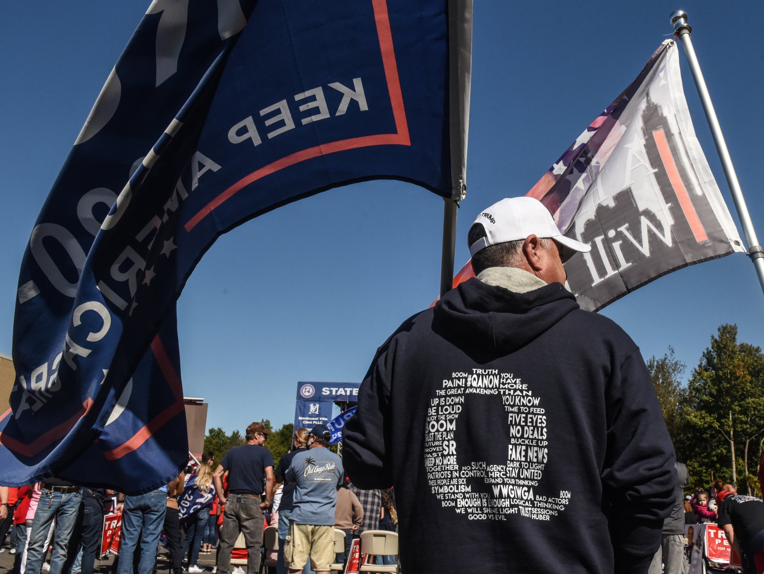 Supporters of Donald Trump wear QAnon branded clothes at rally